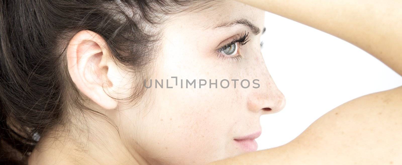 Angelic white portrait of beautiful young girl with freckles