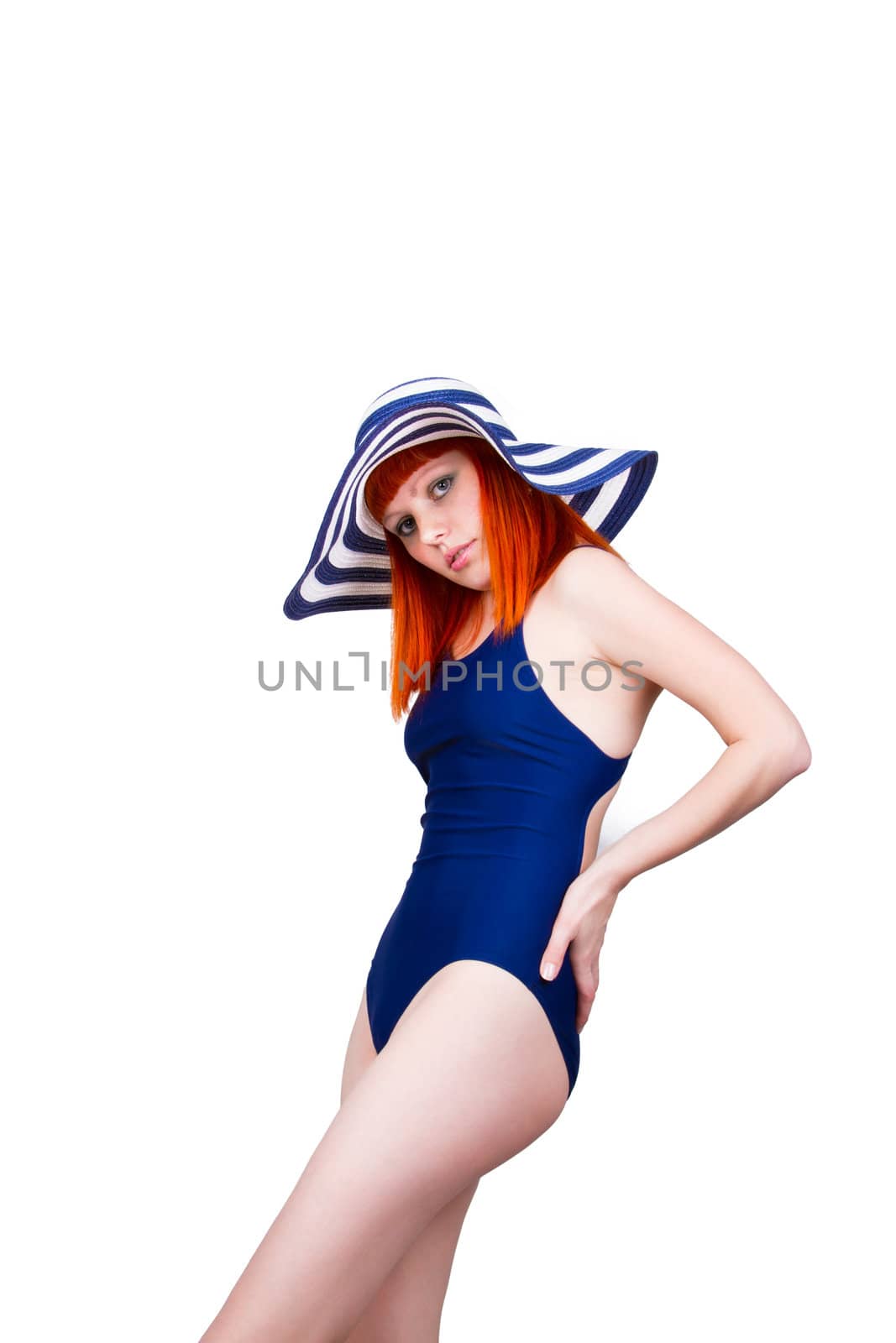 Beautiful young woman in a blue swimsuit standing isolated on white