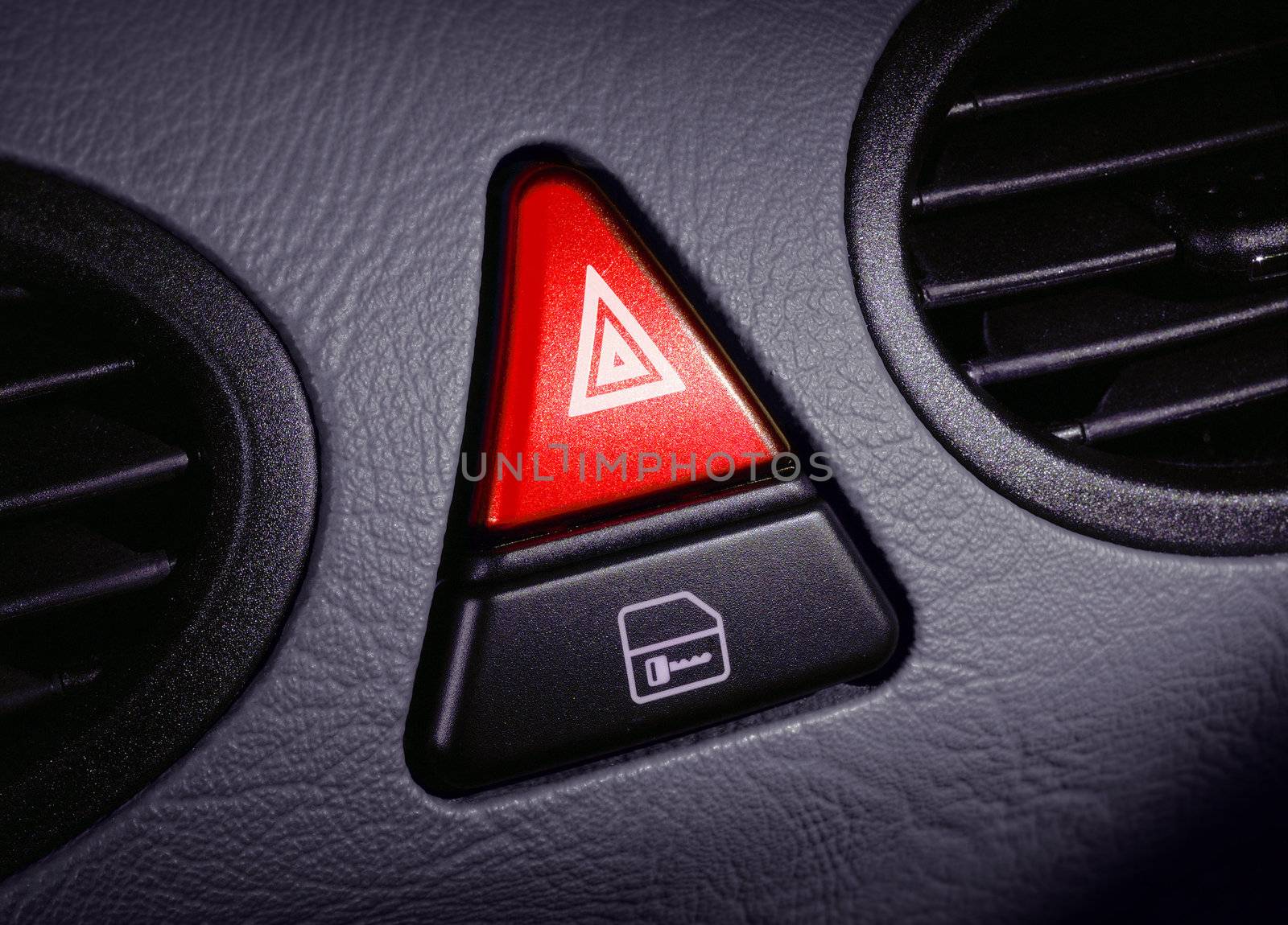 red emergency button on a dashboard of car