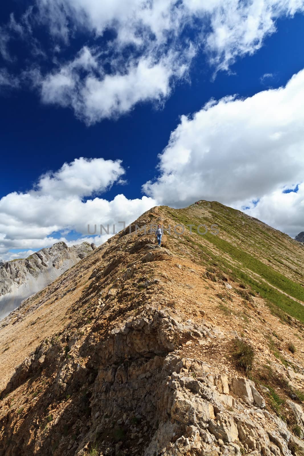 hiker is walking on Monzoni ridge, Italian Dolomites