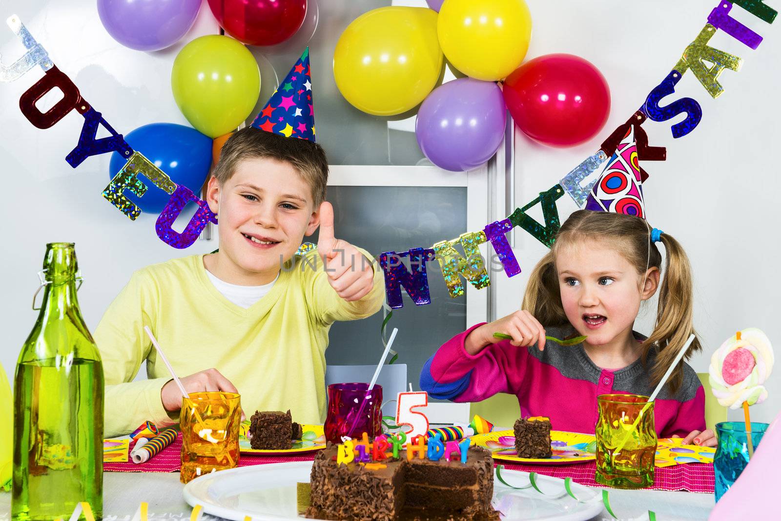 Happy little children are having fun in a birthday party 