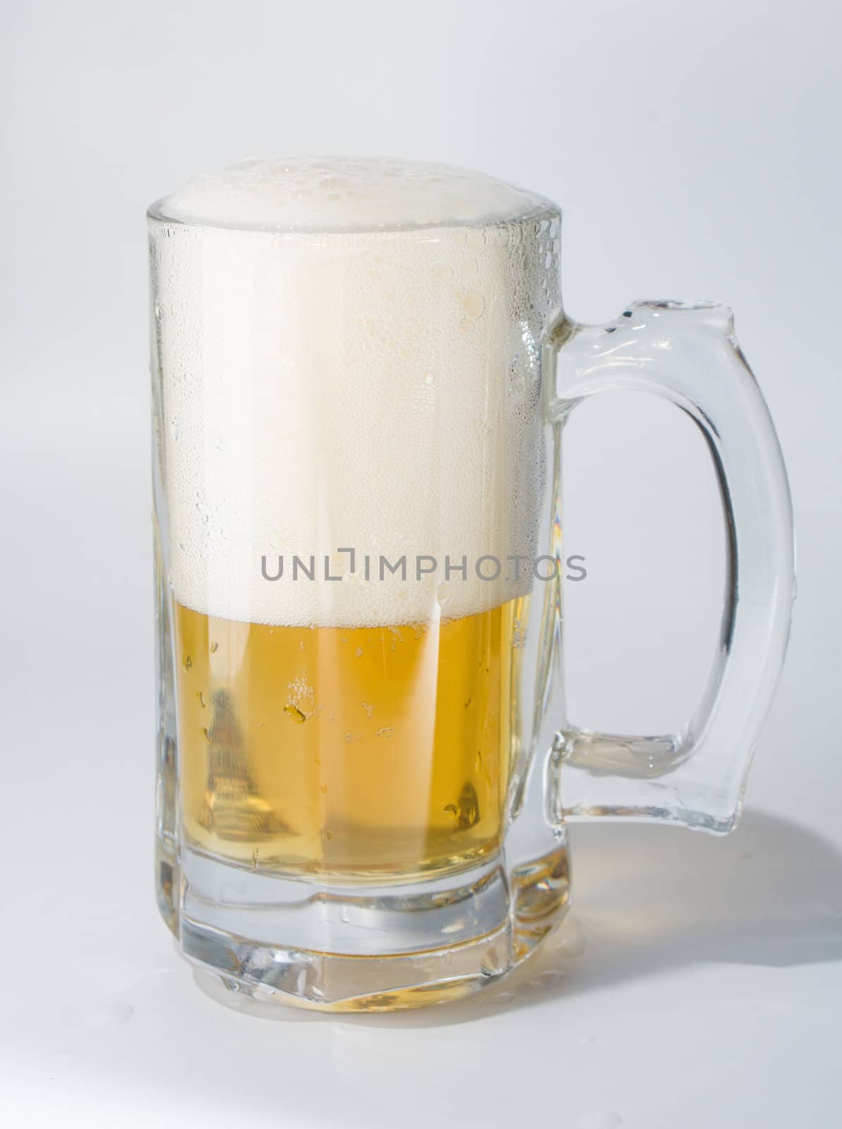Mug, full of cold lager beer. Isolated.