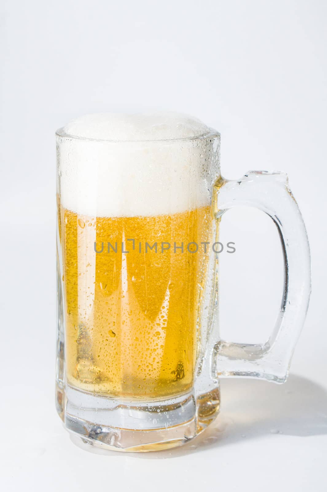 Mug, full of cold lager beer. Isolated.