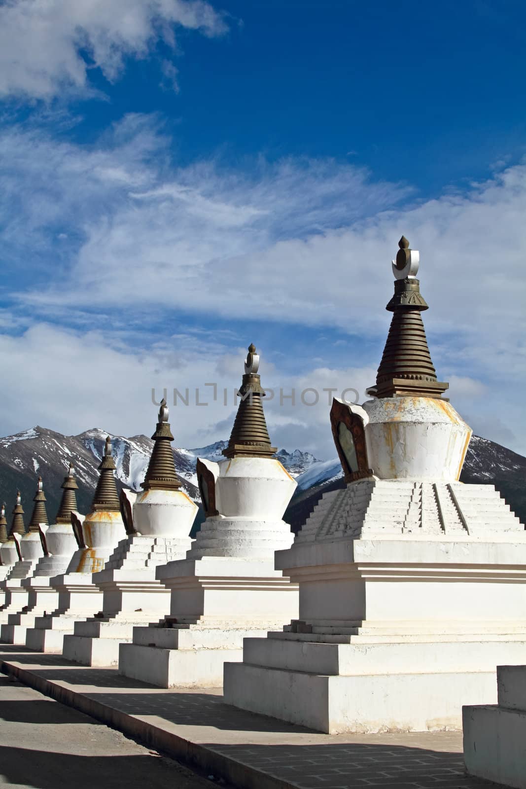 White pagodas Tibet with mountain and blue sky