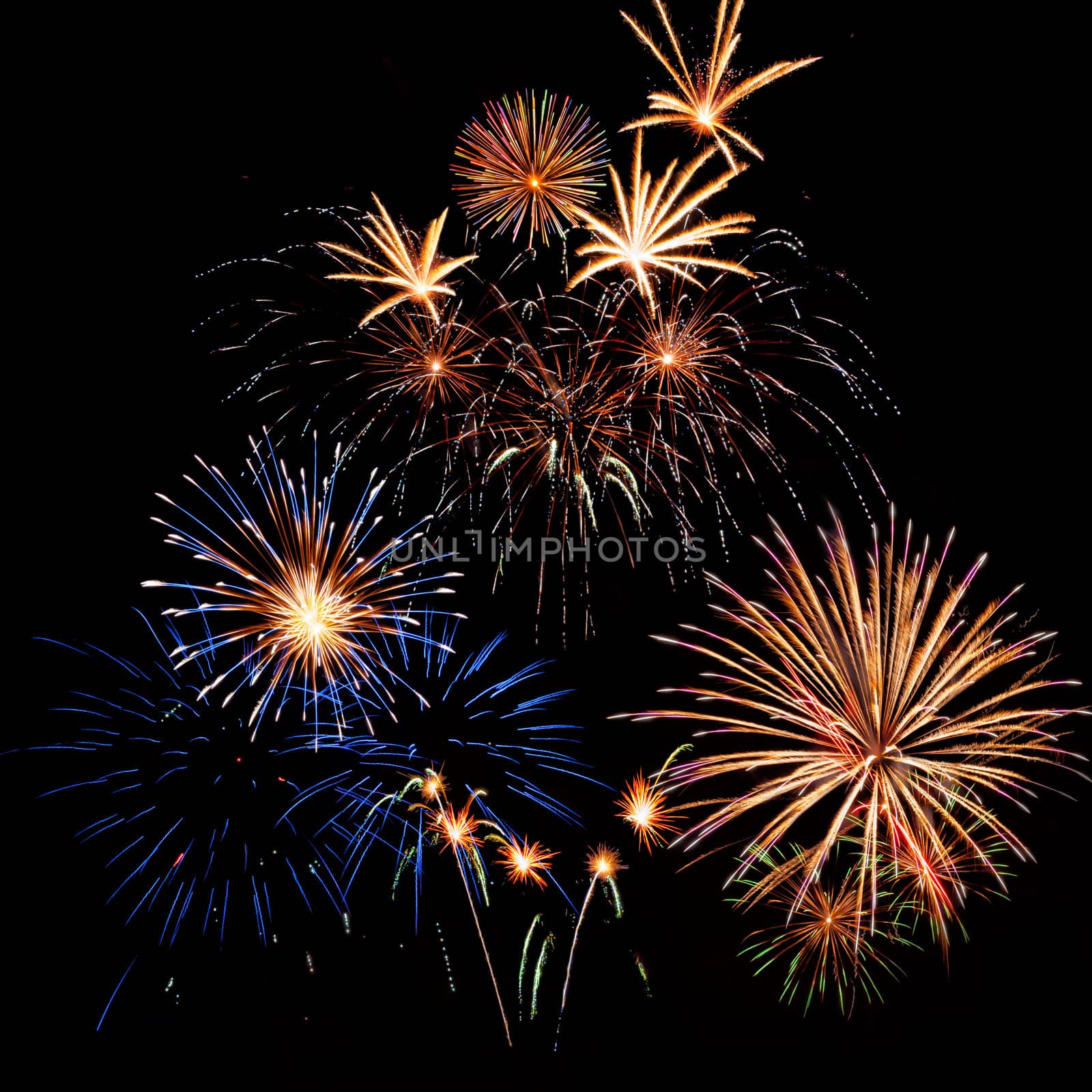 Bright colorful holiday fireworks on the black sky background,  long exposure