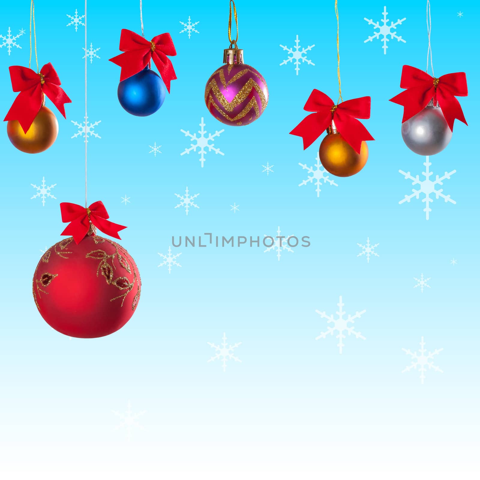 Winter background with christmas balls on ribbon and snow on festive background