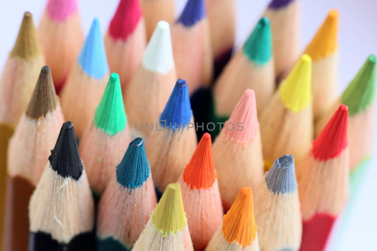 An extreme macro view of colour pencils arranged in a row