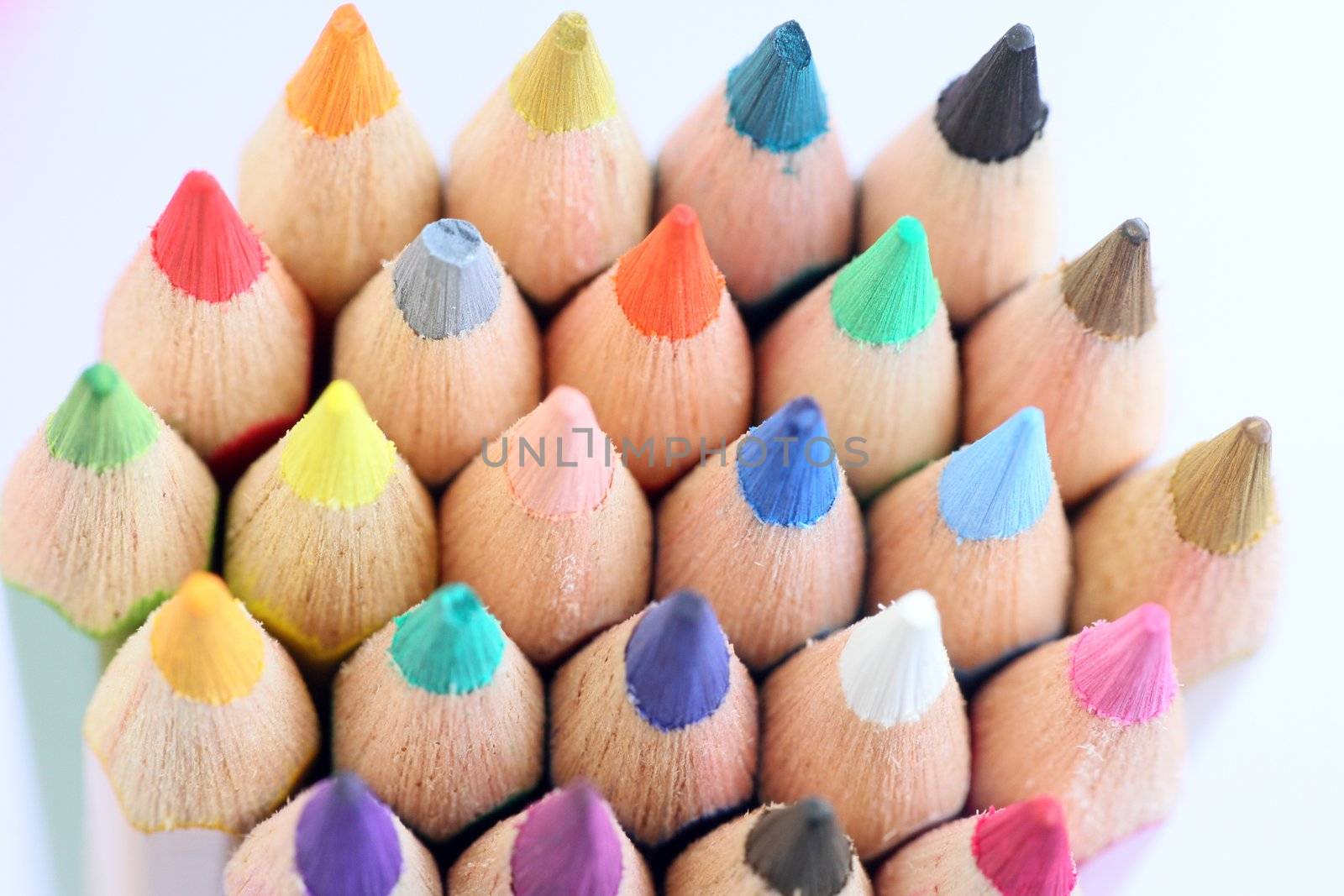 An extreme macro view of colour pencils arranged in a row