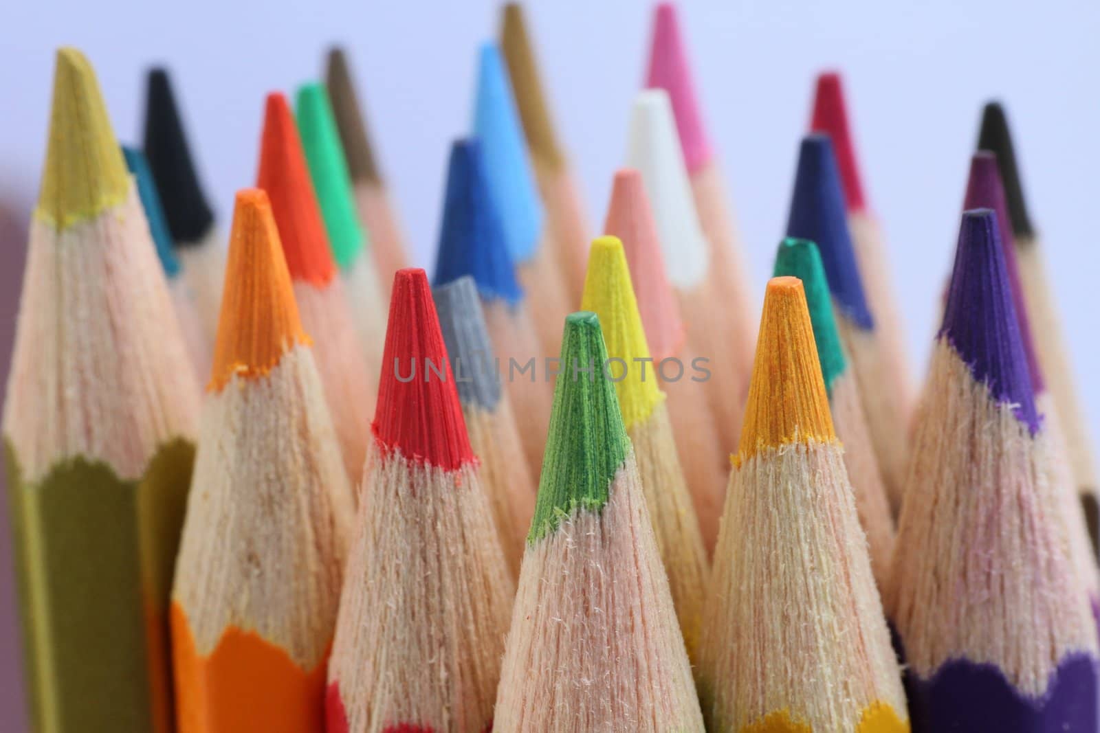 An extreme macro view of colour pencils arranged in a row