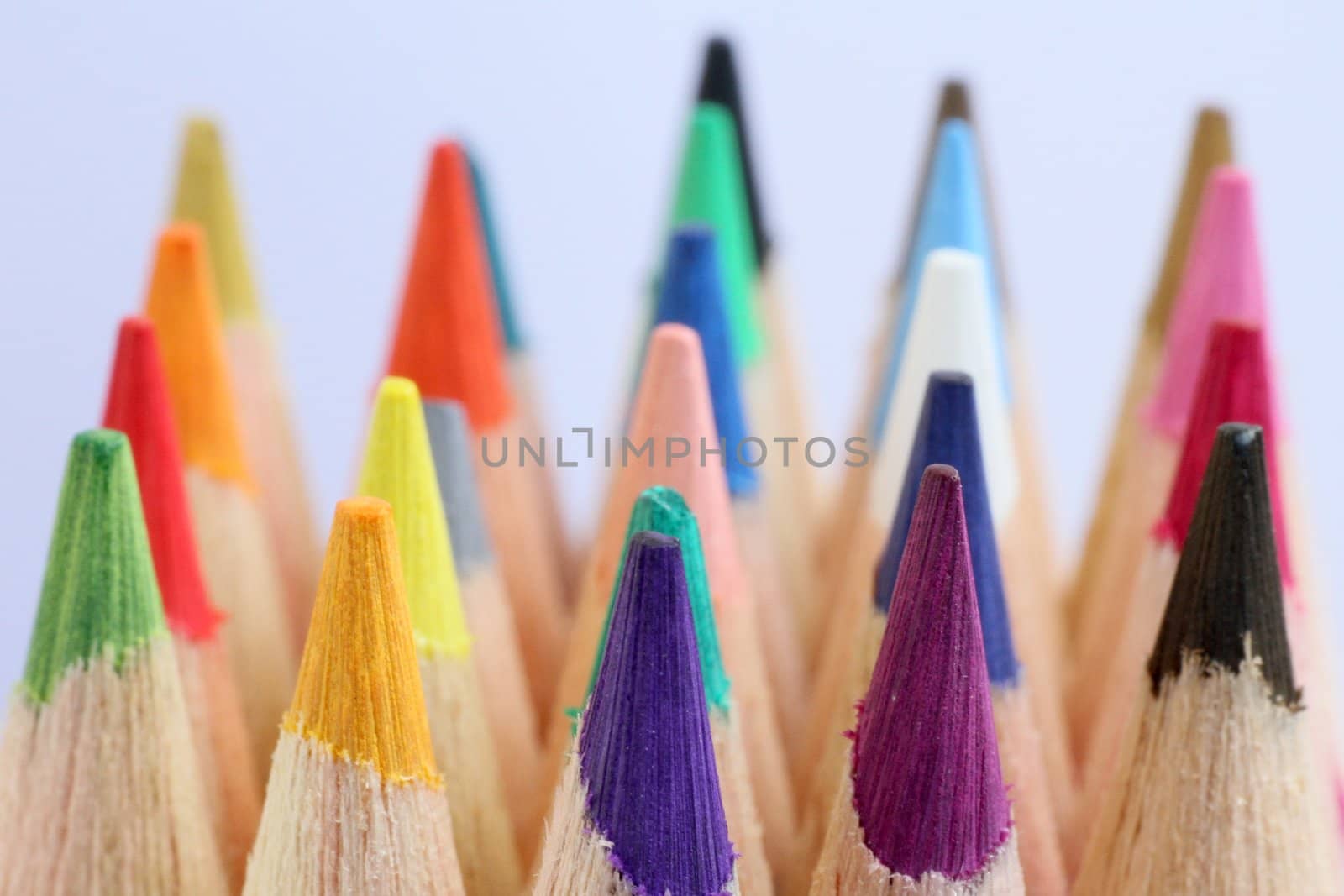 An extreme macro view of colour pencils arranged in a row