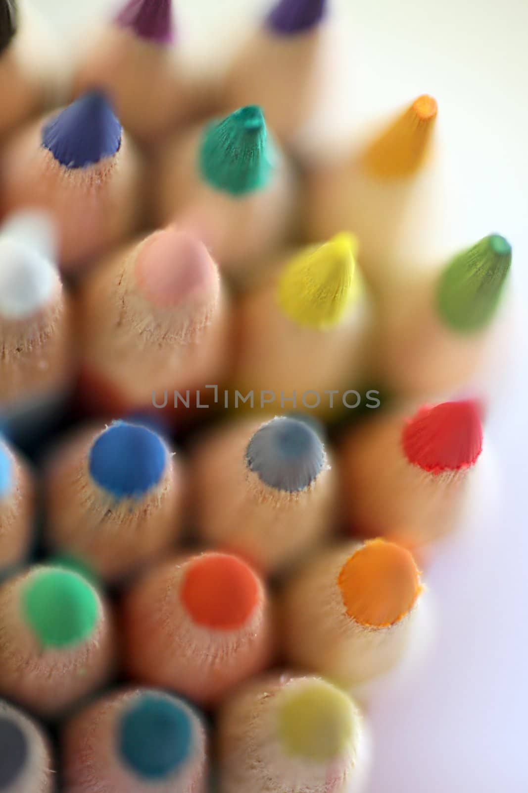 An extreme macro view of colour pencils arranged in a row