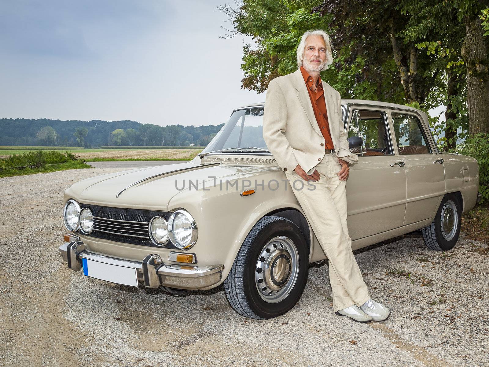 man in front of his car by magann