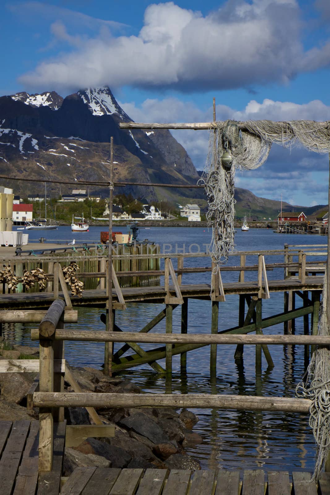 Old wooden pier in town of Reine on the coast of fjord on Lofoten islands, Norway
