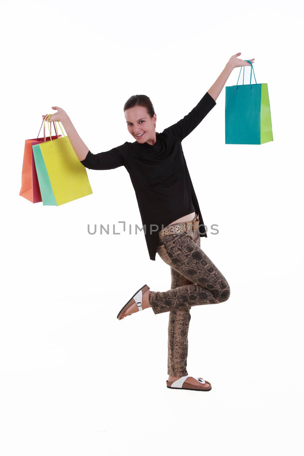 Young woman with colorful shopping bags isolated