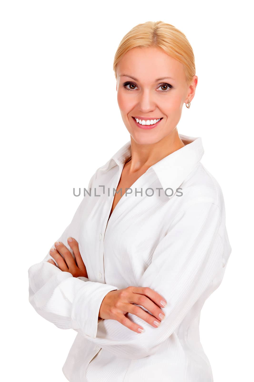 Beautiful young businesswoman standing with hands folded against white background.