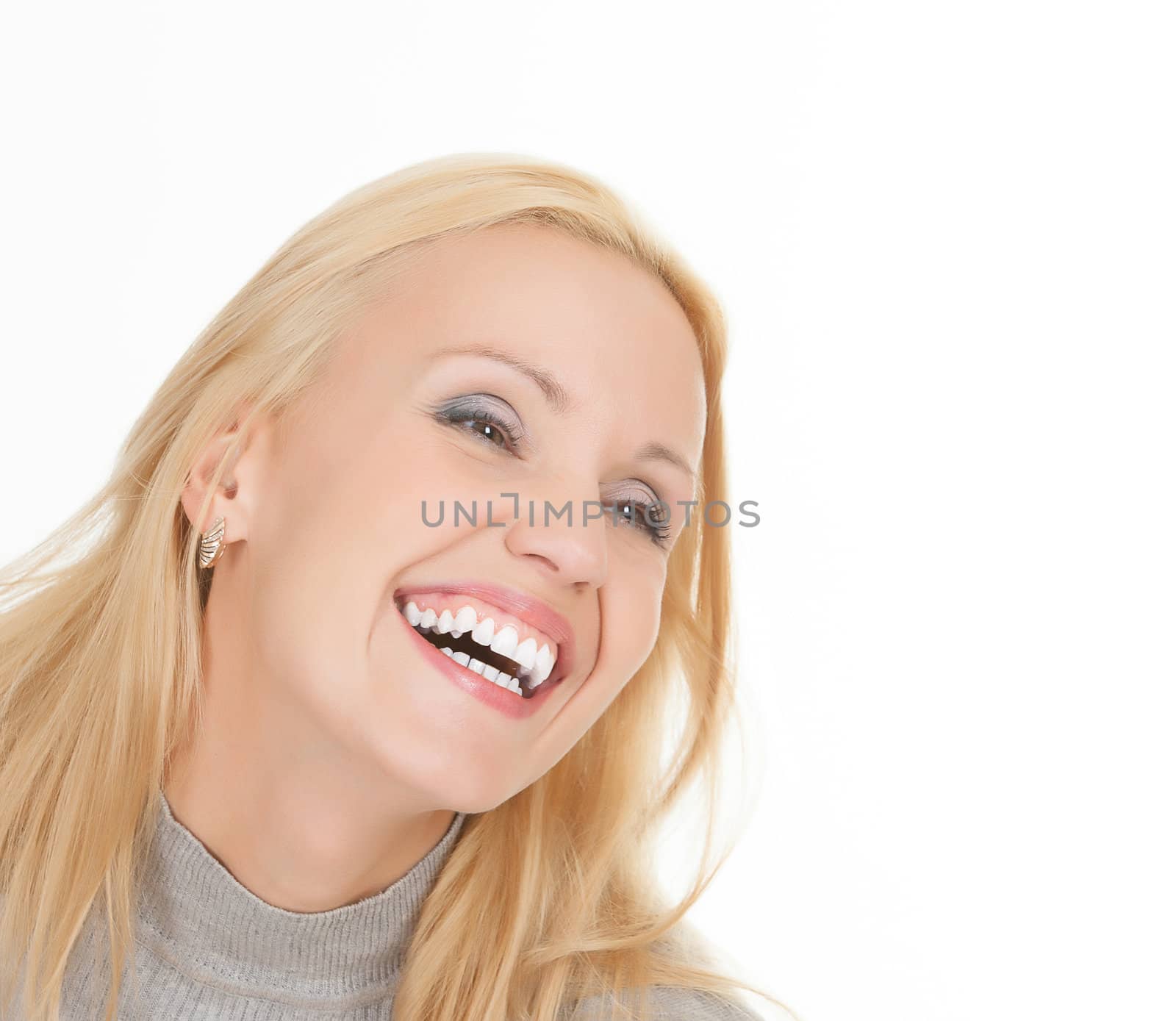 excited young woman laughing against white background