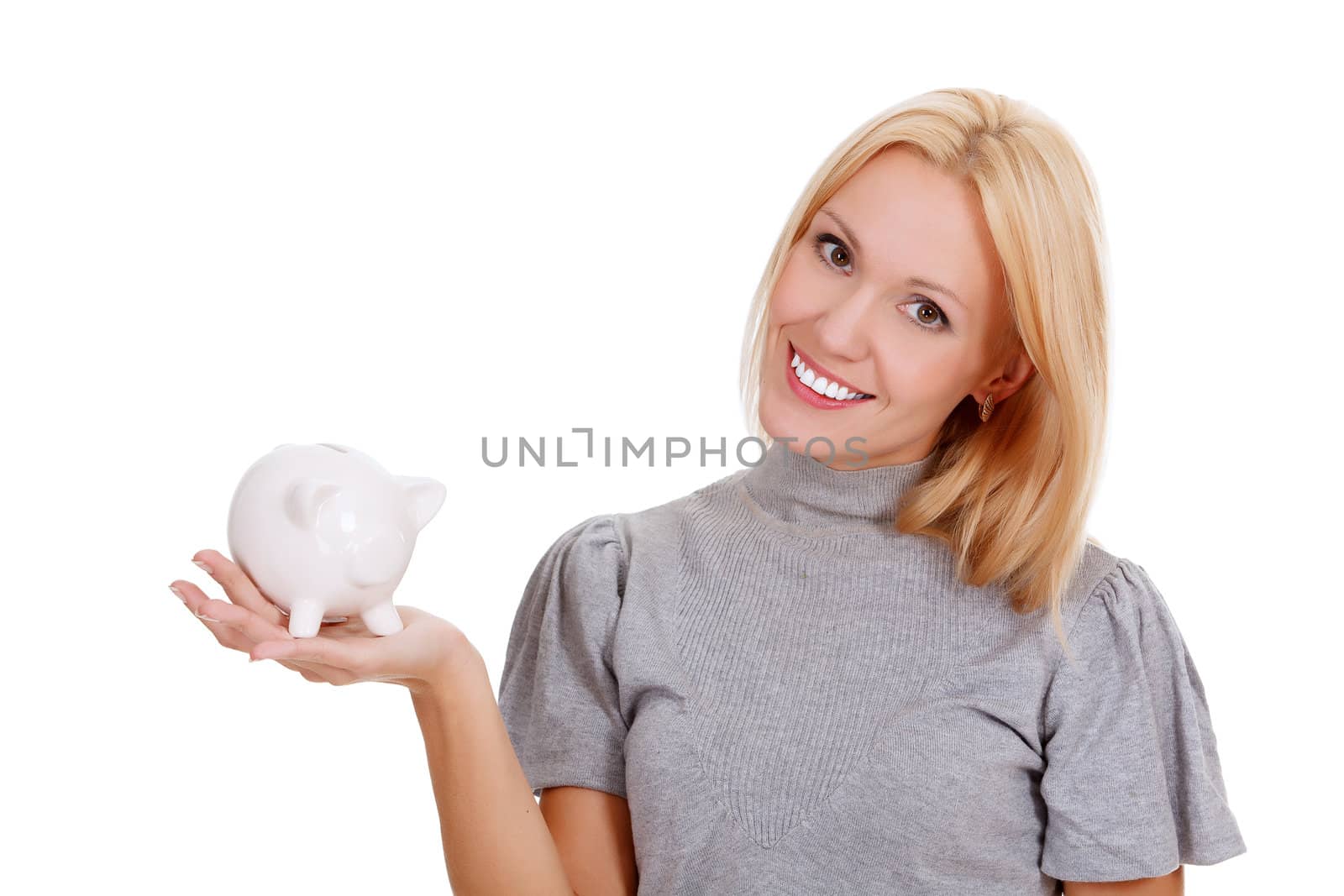 Smiling woman with piggy bank posing against white background