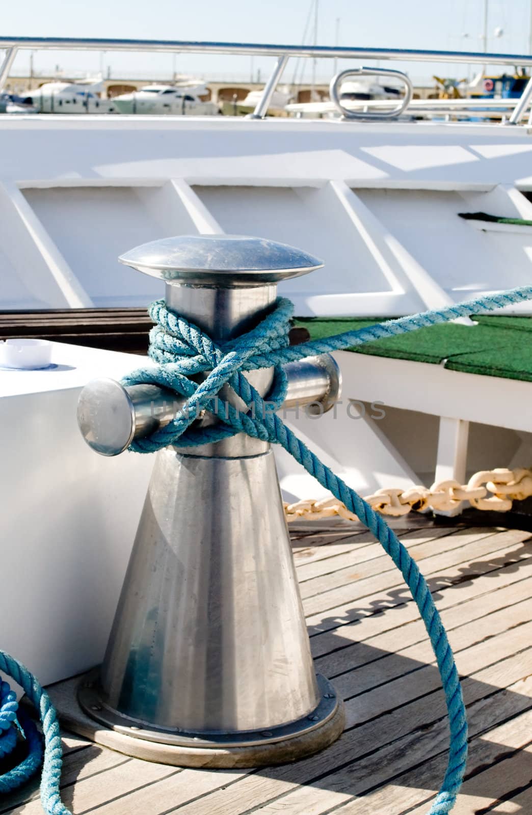 Single bit bollard with mooring rope tied around it. 