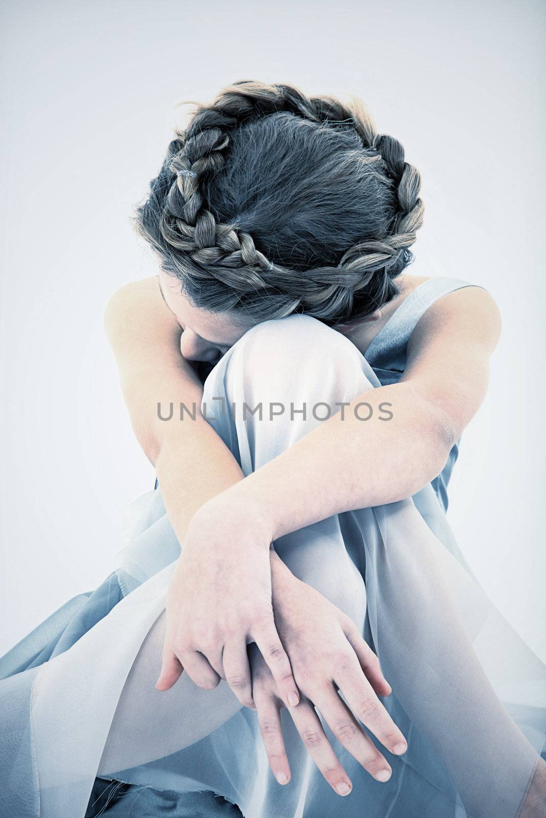 Sad and Lonely ten year old girl in dress looking down.