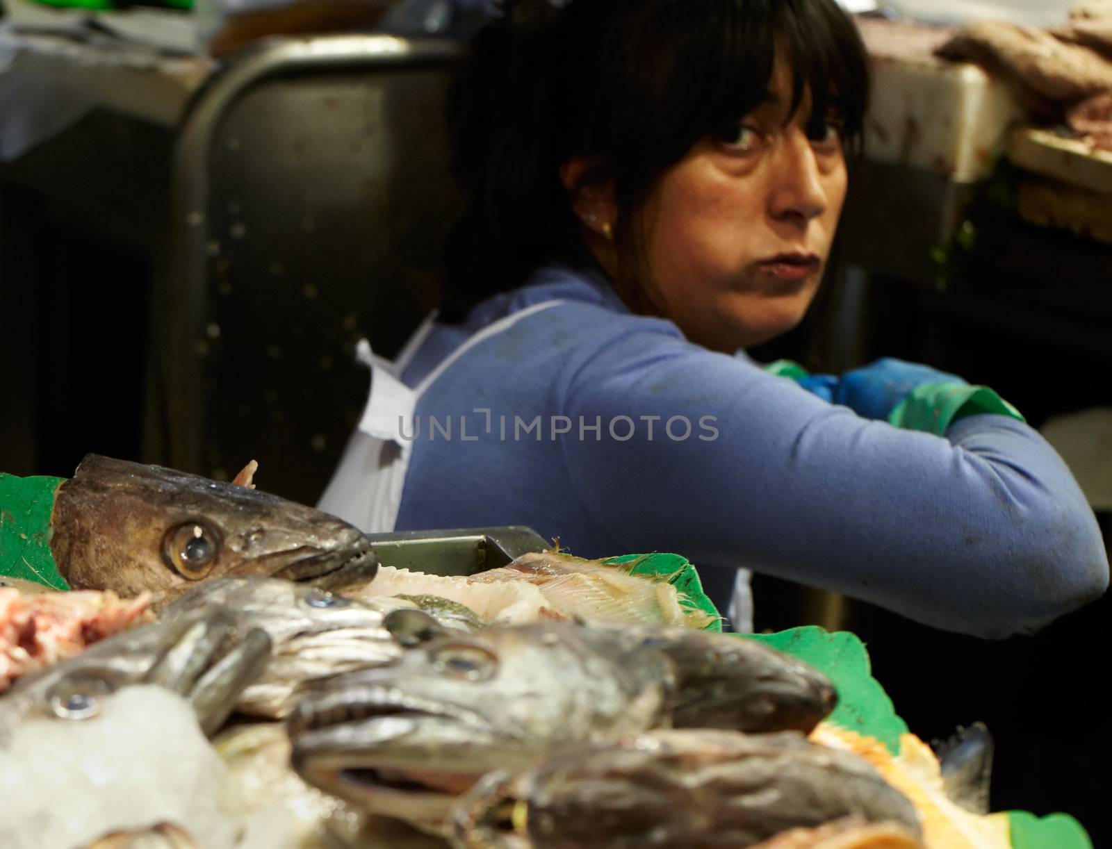 BARCELONA - MAY 26: The fish monger lady at the market, looking at the camera on May, 26, 2012 in Barcelona, Spain.