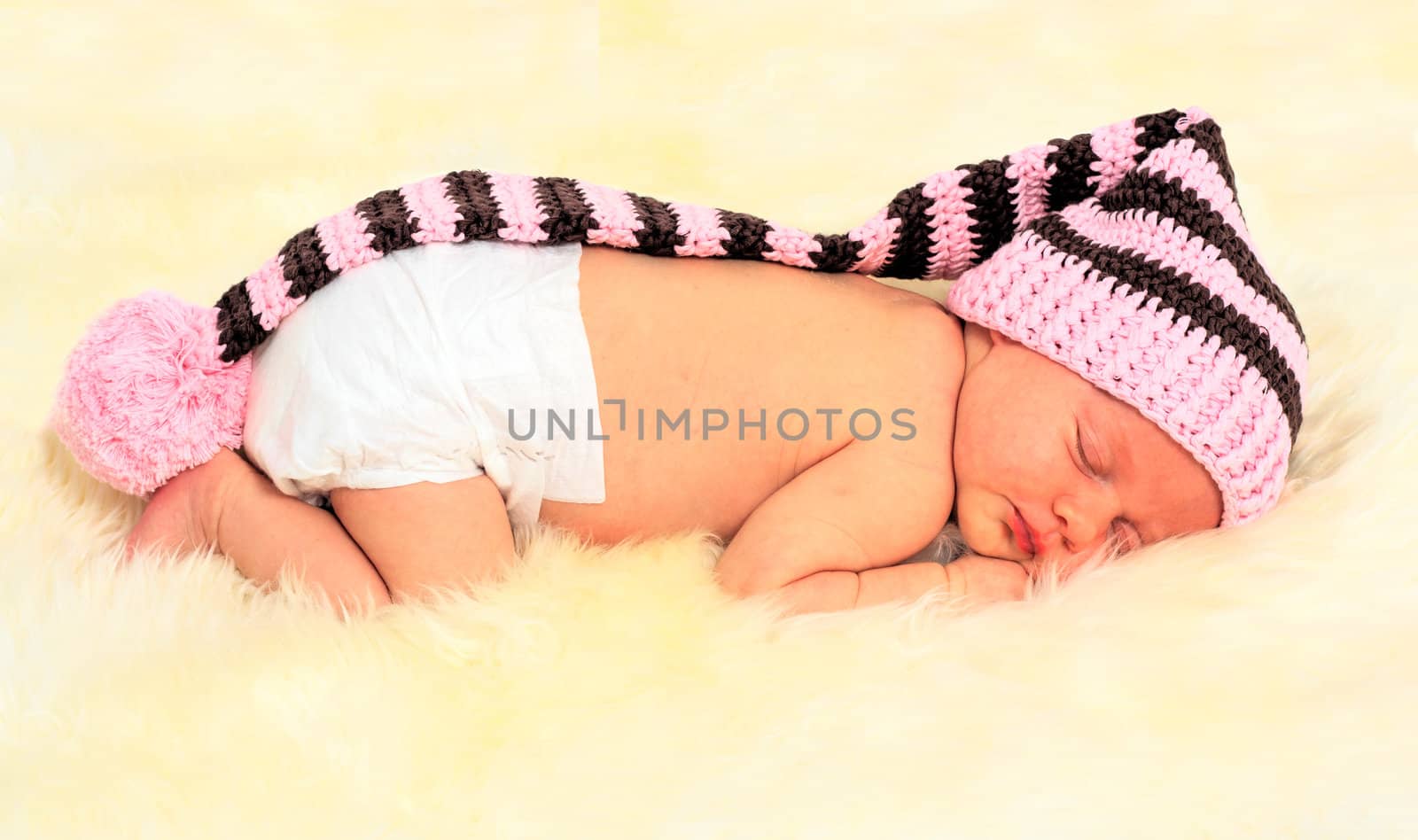 infant sleeping in the white sheep's clothing.