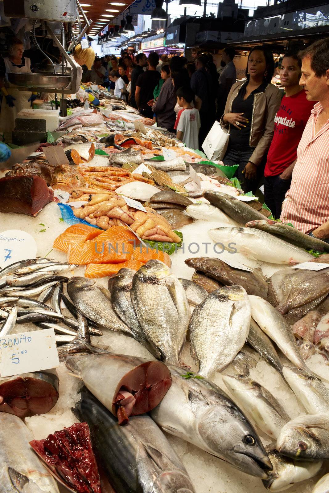 BARCELONA - MAY 26: The buyers of fish at the market on May, 26, 2012 in Barcelona, Spain.