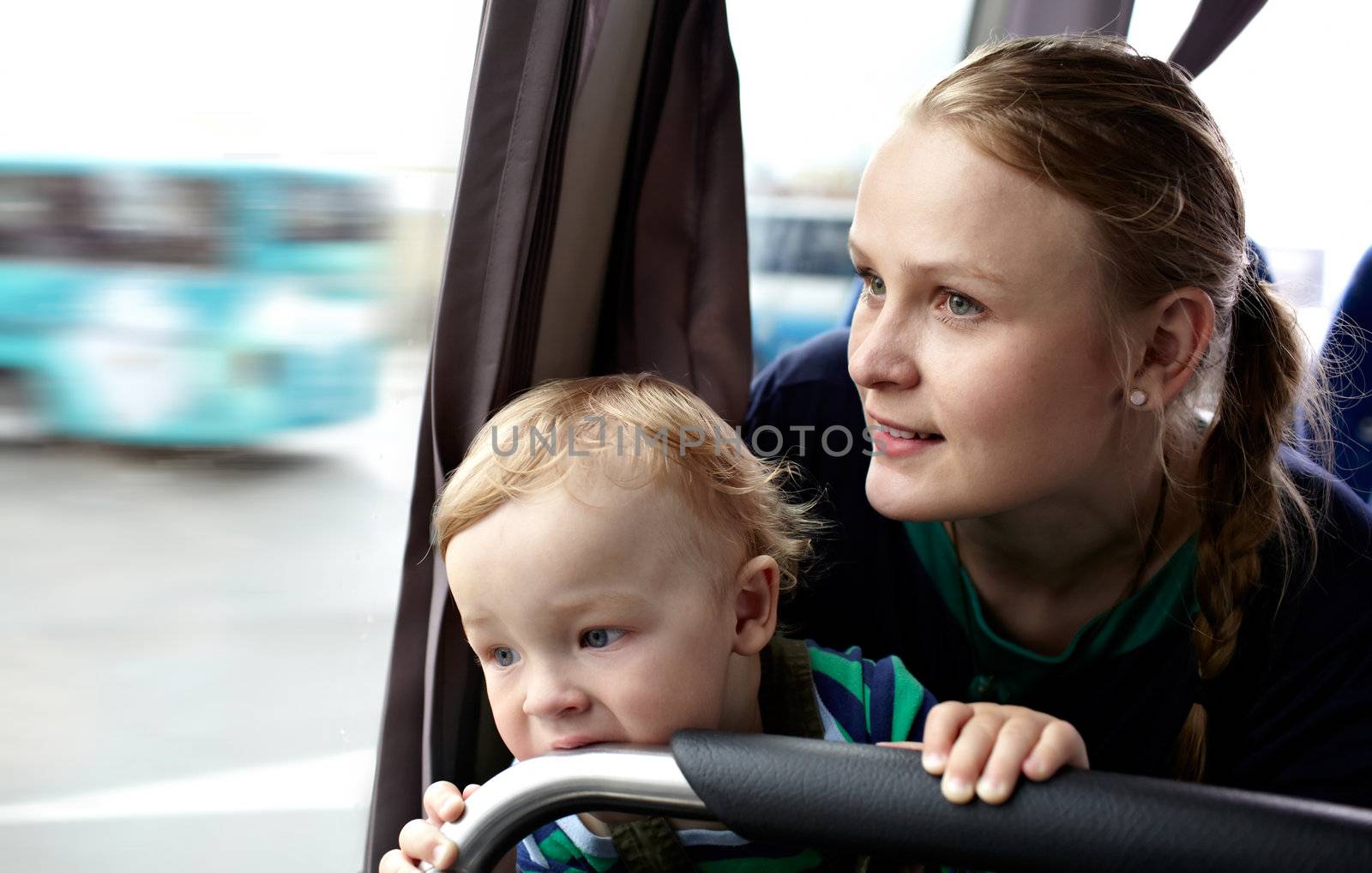 Young mother with her 16 month-old babyboy is traveling by bus.