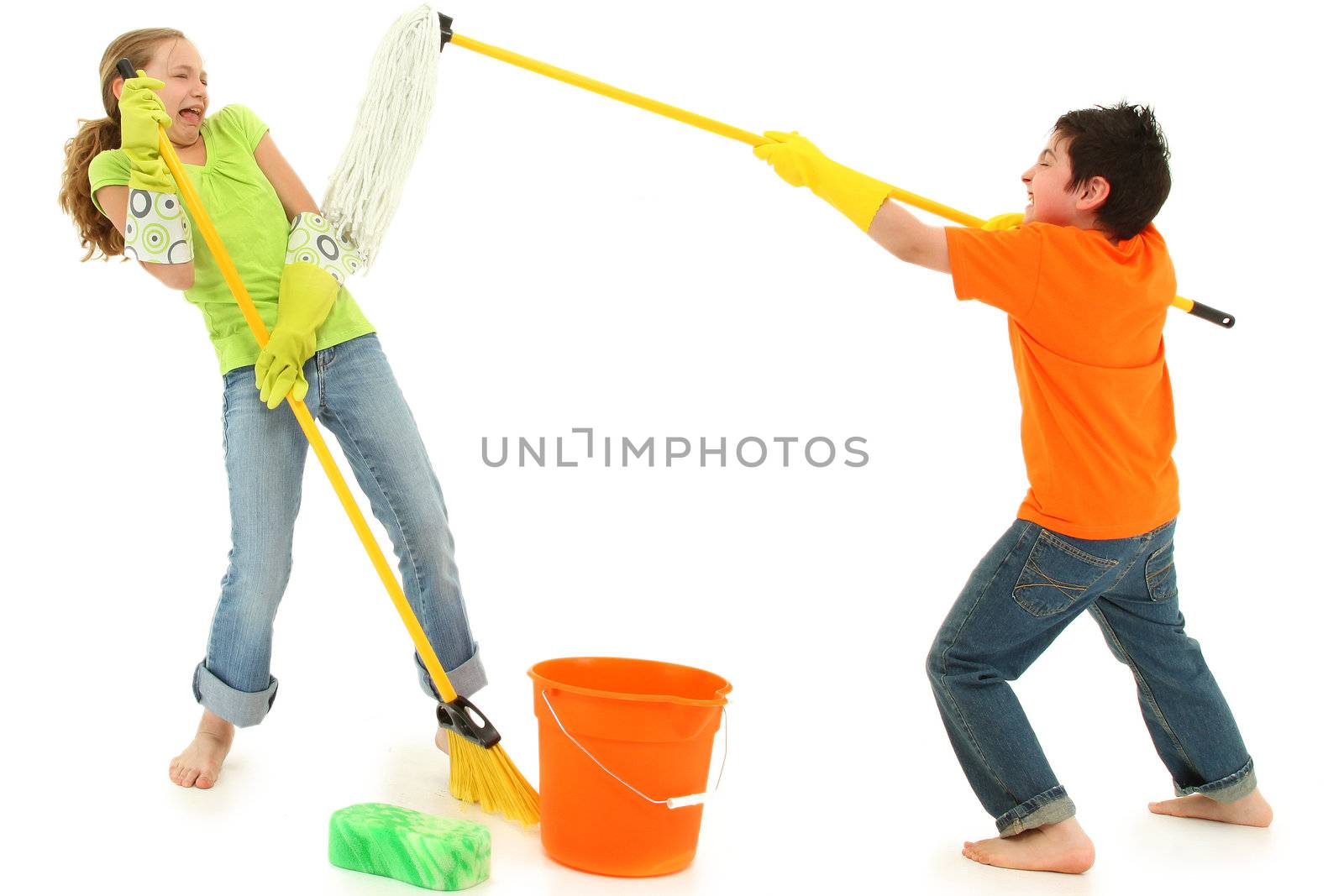 Spring cleaning 9 year old kids playing with stinky mop over white background barefoot in casual.