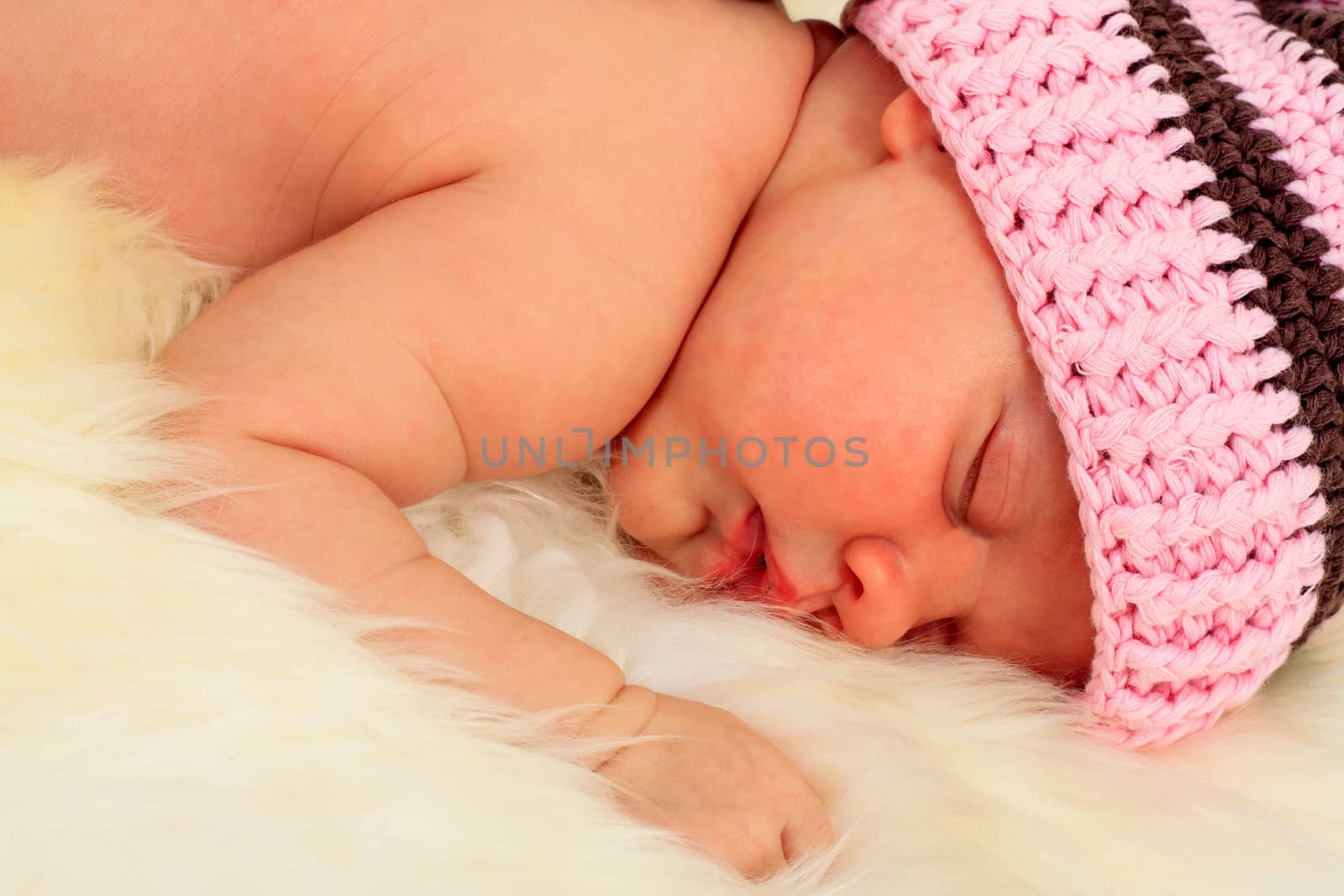 infant sleeping in the white sheep's clothing.