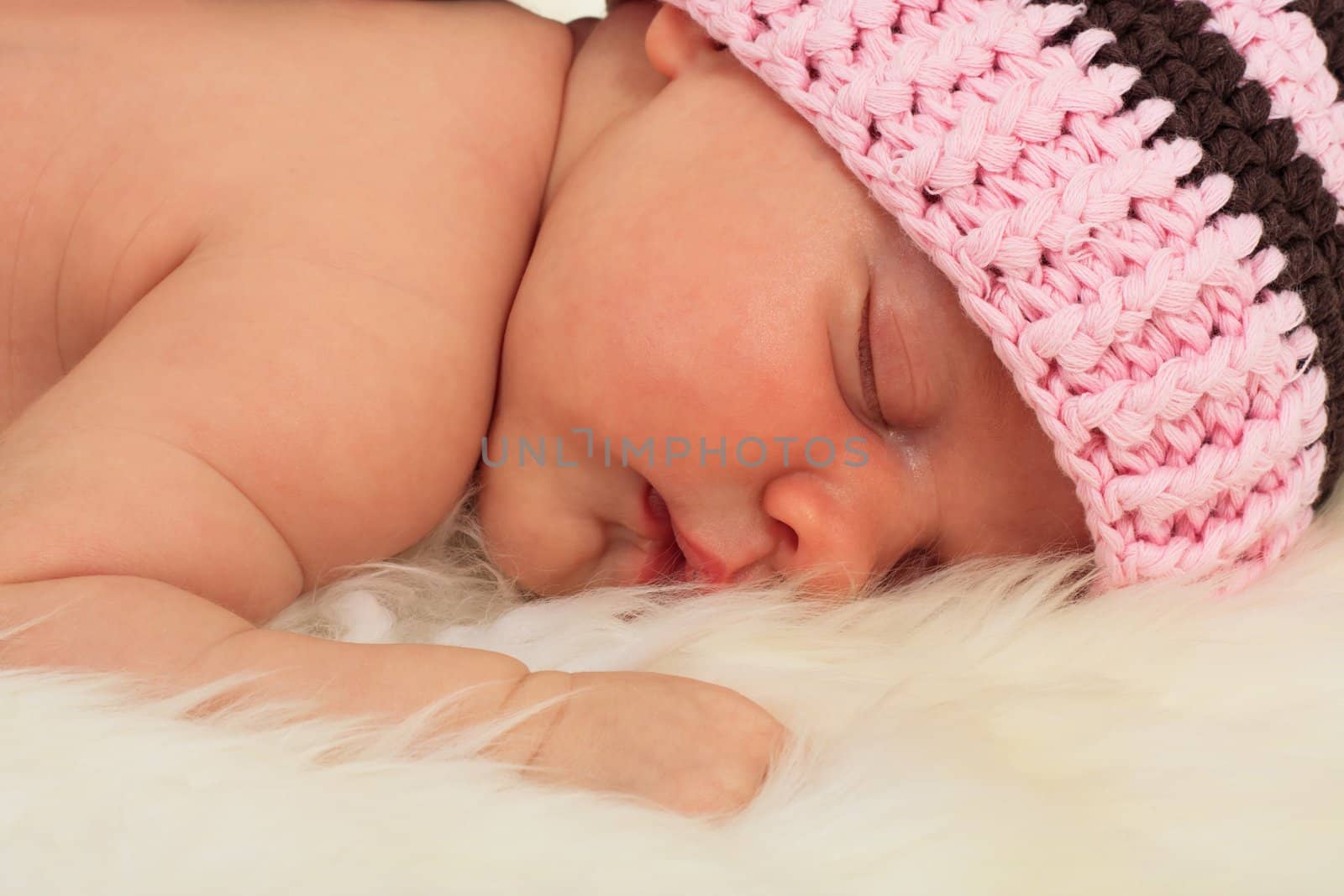 infant sleeping in the white sheep's clothing.