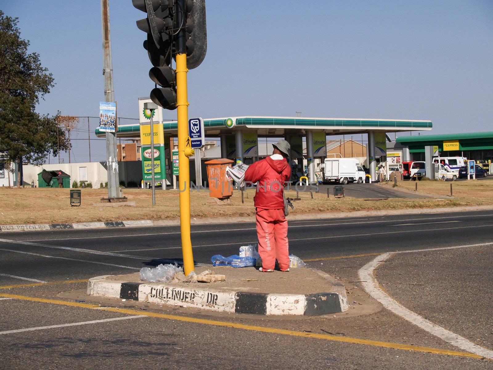Man stands on South African road selling. by brians101