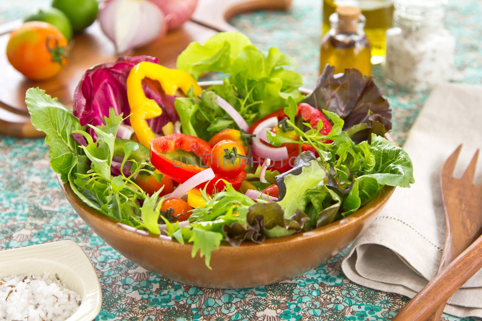 Fresh Vegetables salad in wood bowl by herbal salt and chilli oil