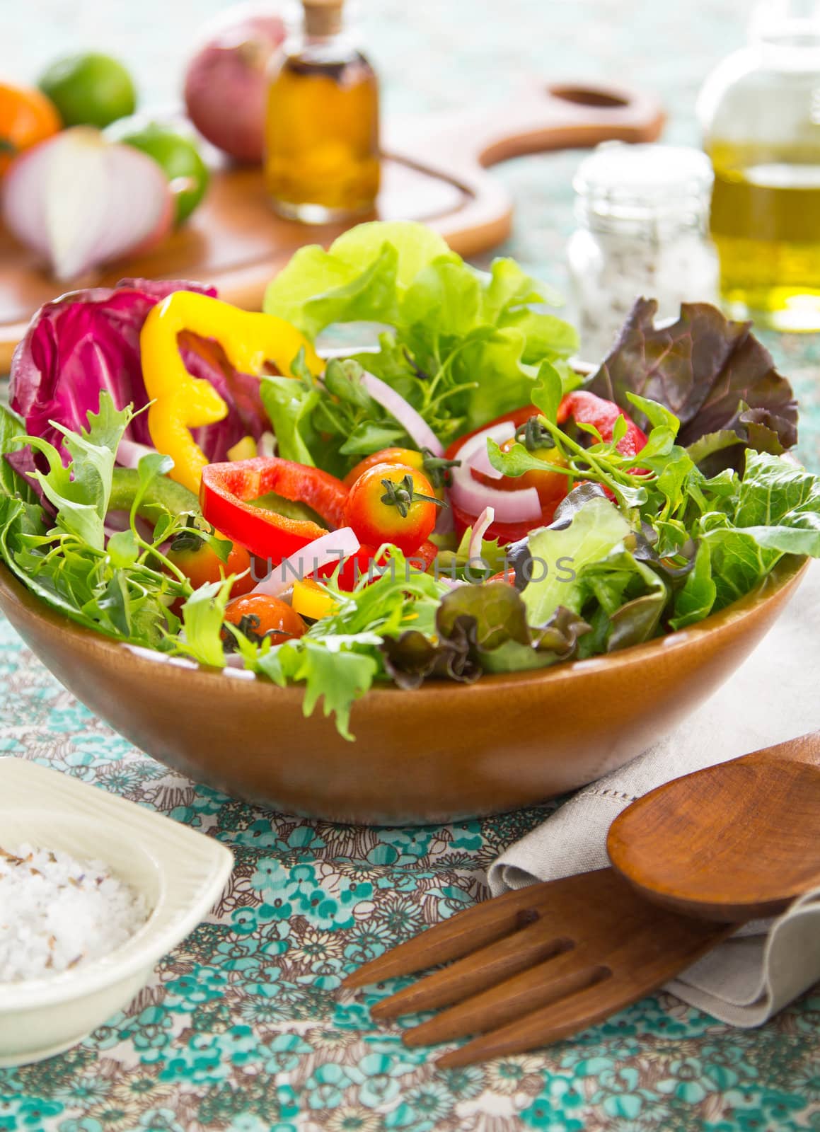 Fresh Vegetables salad in wood bowl by herbal salt and chilli oil