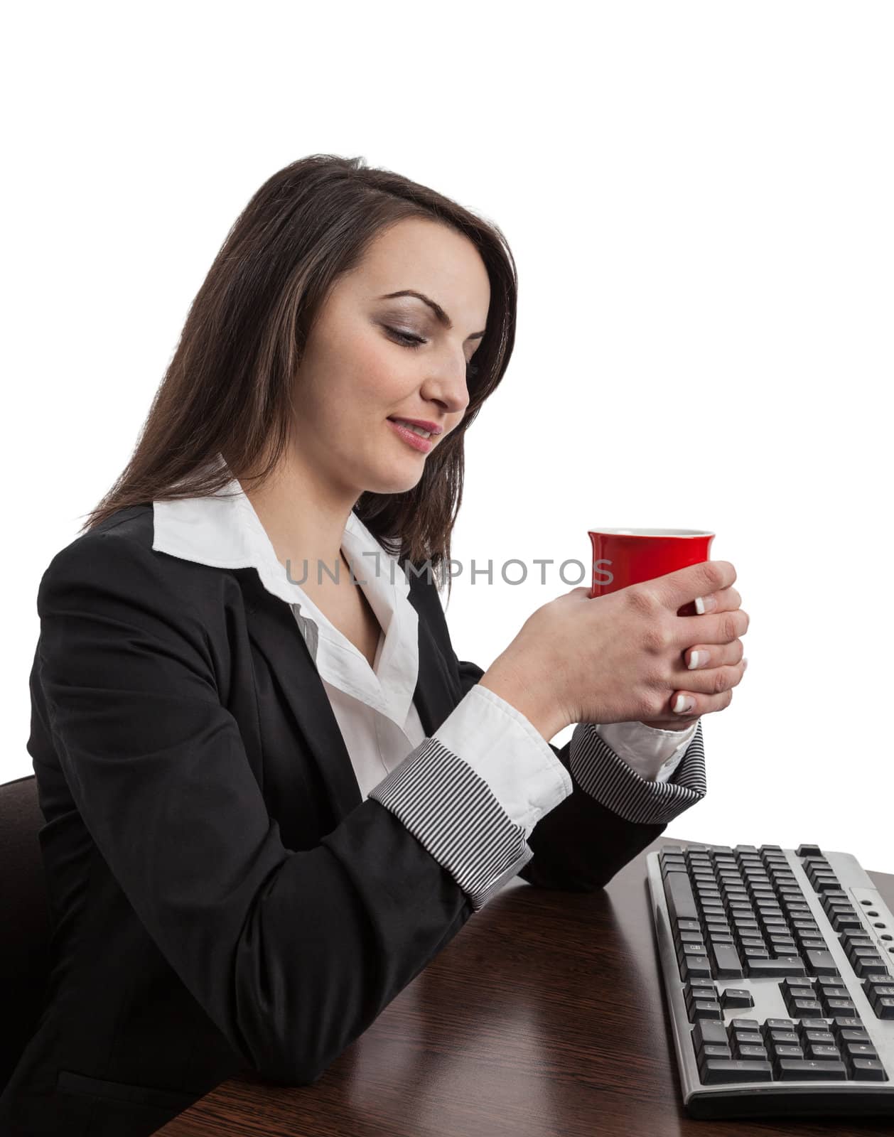Portrait of a young businesswoman enjoying a cup of coffee at her workplace in the office.