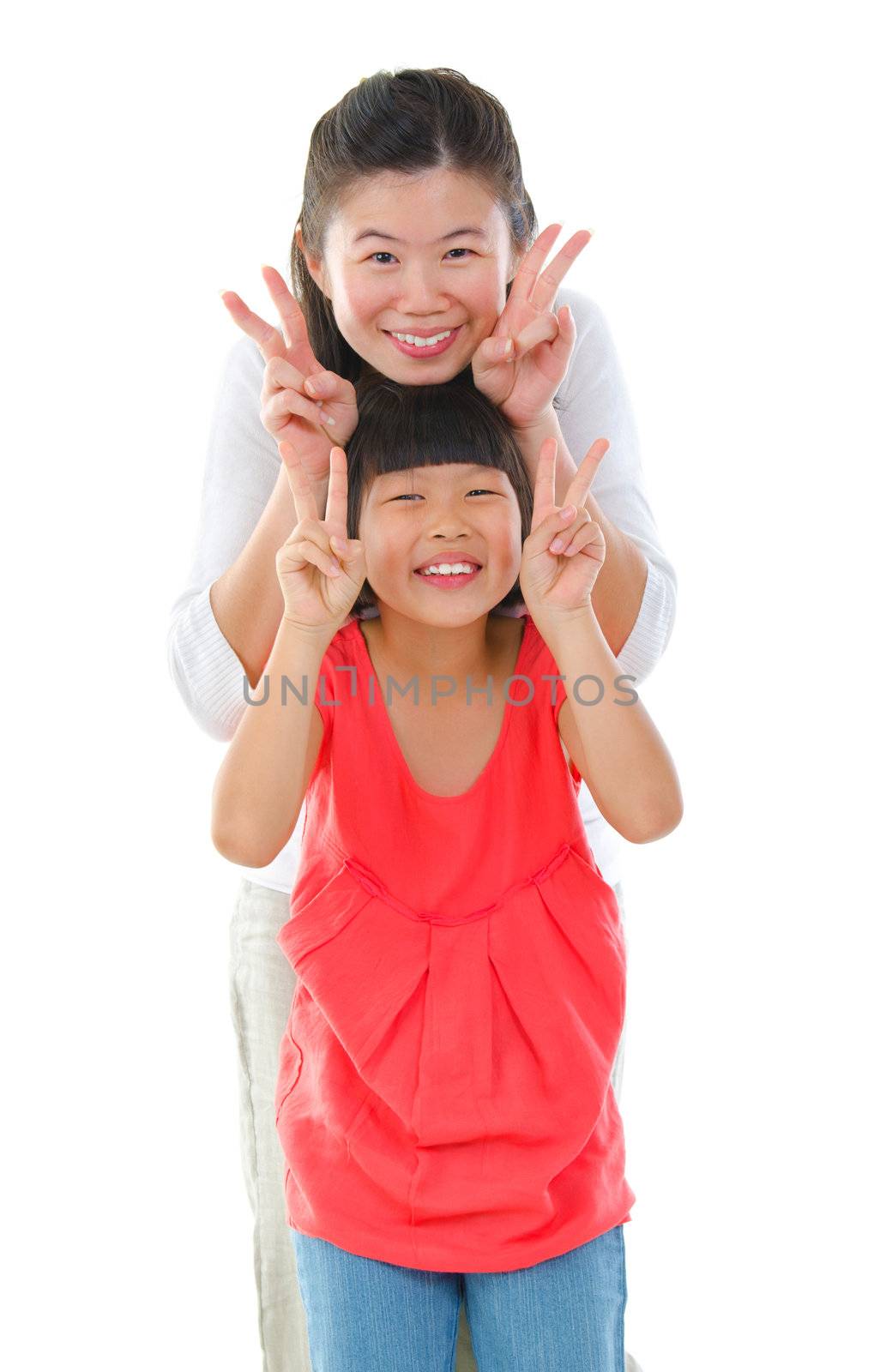 Little Asian girl and mum gesture v hand sign, isolated on white background