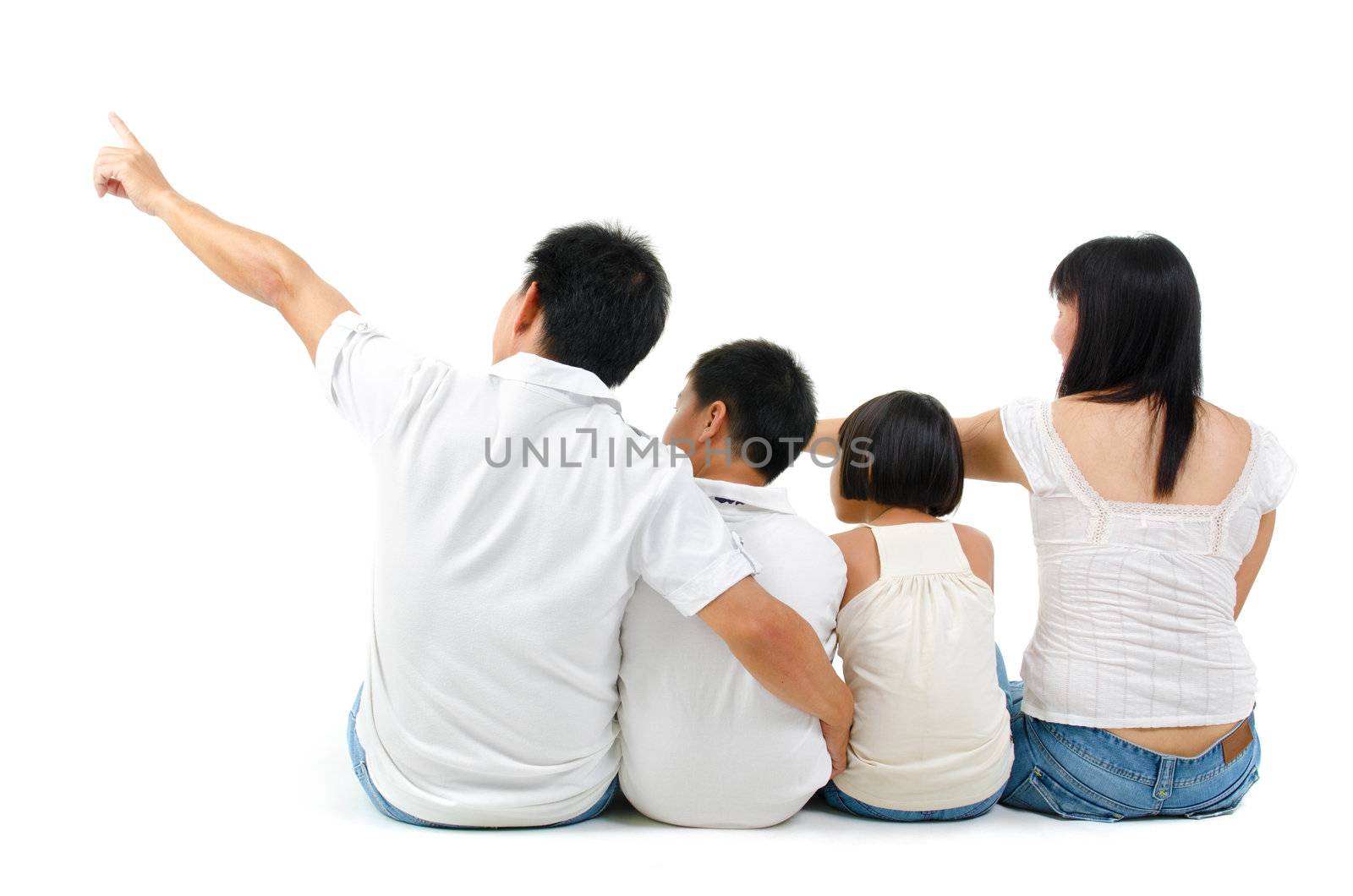 Rear view of Asian family looking at side, sitting on white background