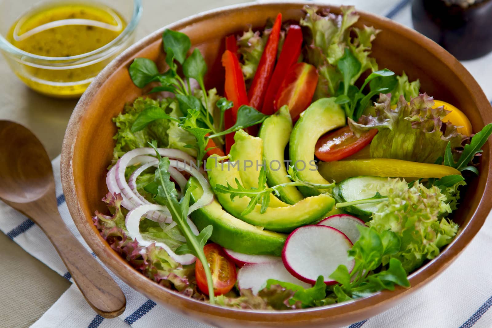 Avocado with pepper,radish and lettuce salad by vinaigrette