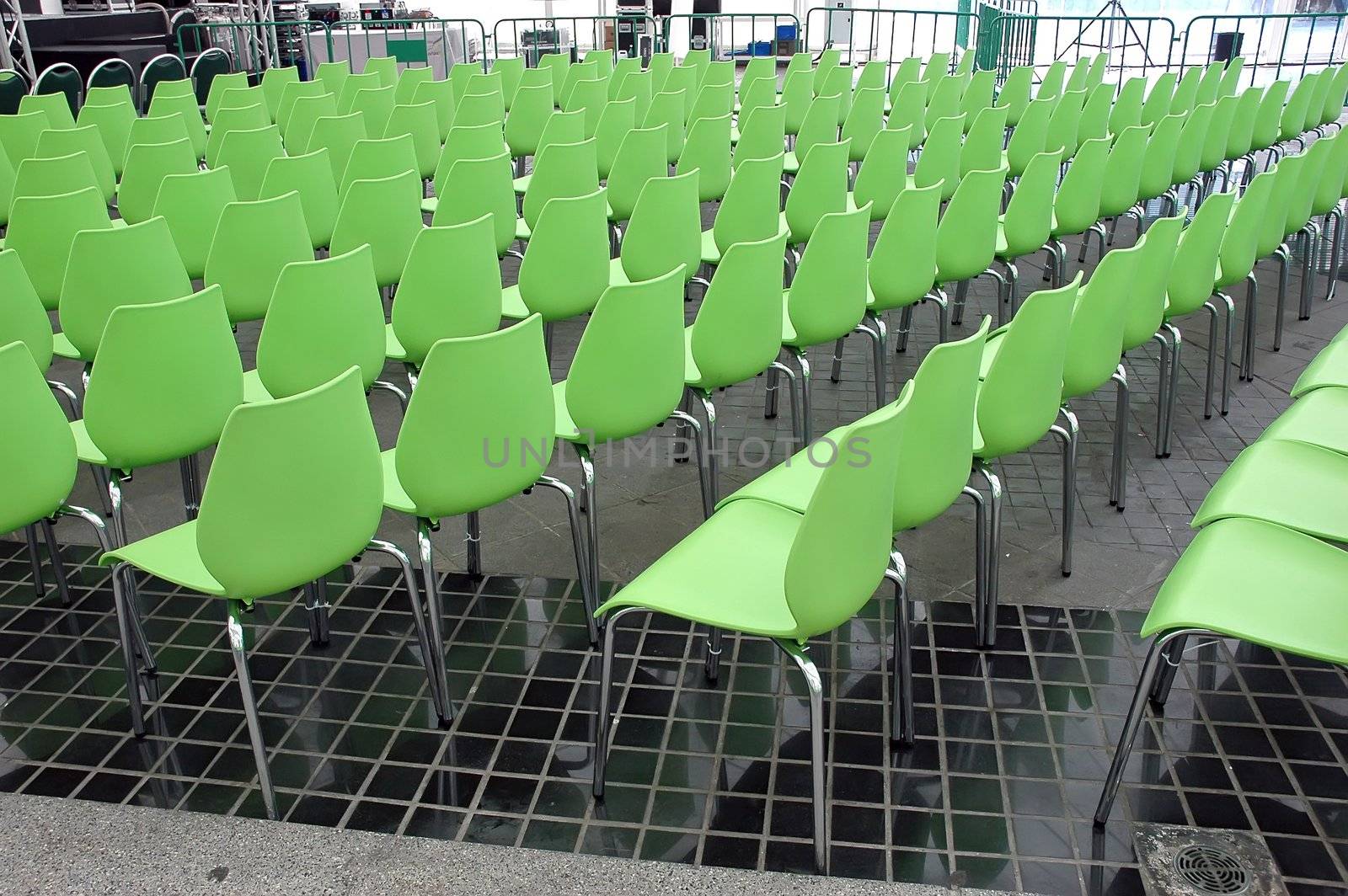 Green chairs rows in conference hall
