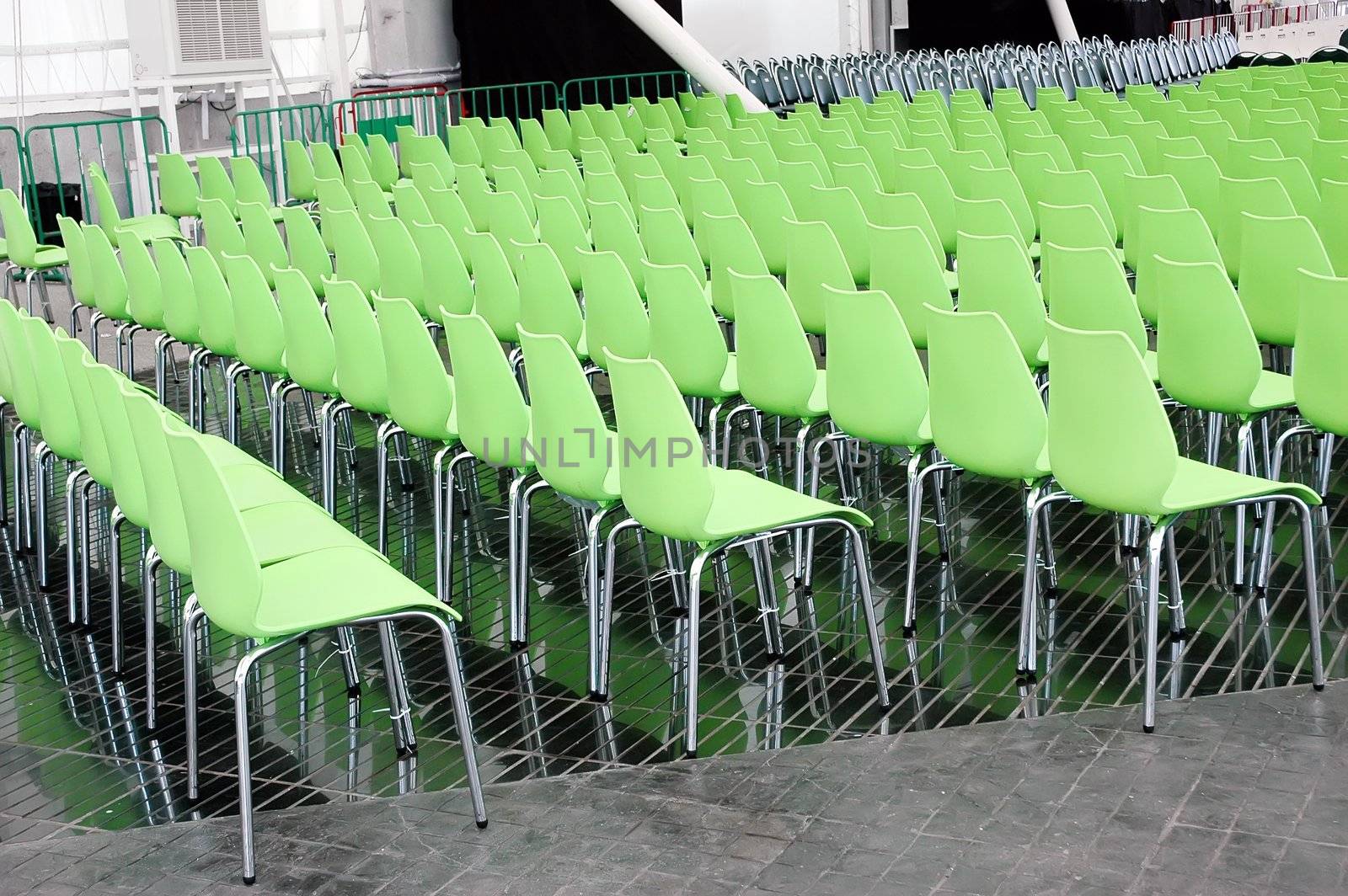 Green chairs rows in conference hall