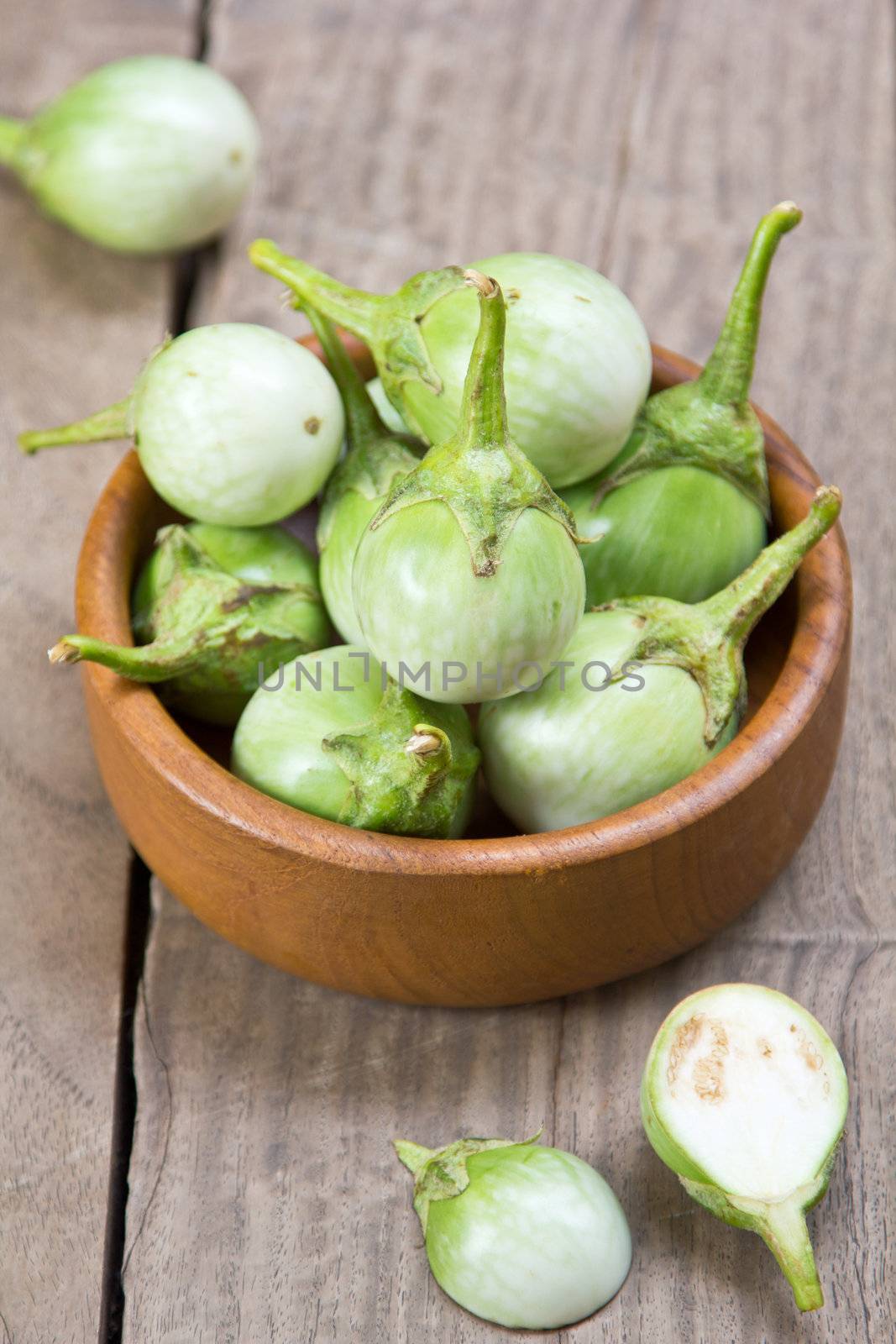 Green small Thai's eggplants in wood bowl