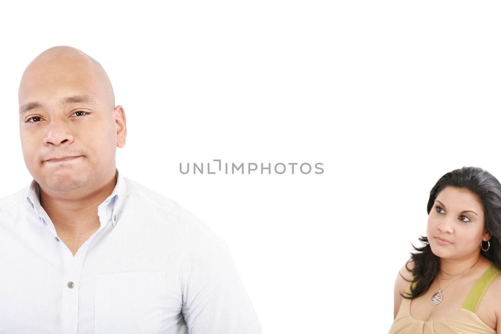 young couple on white background having a dispute. Focus on man