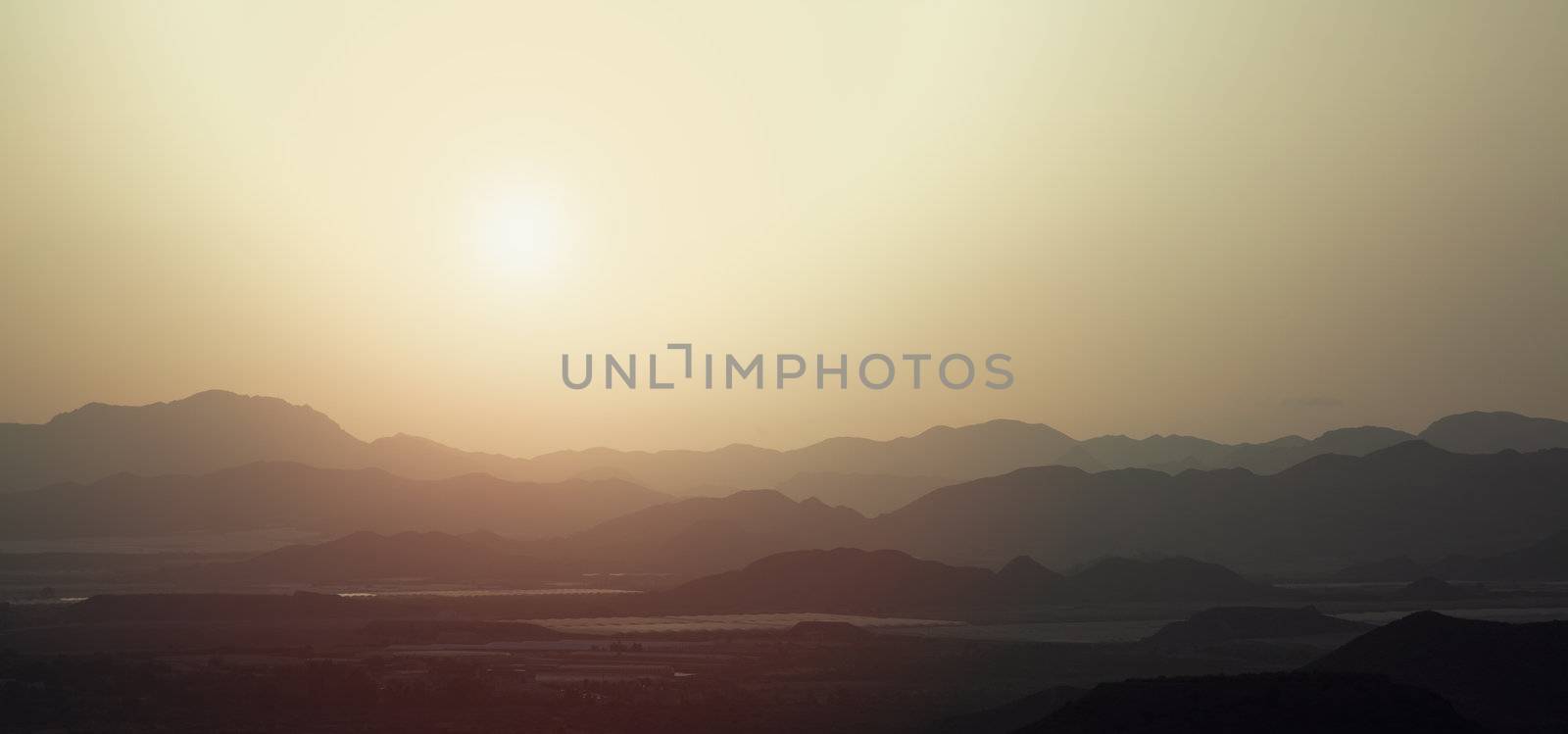 the silhouette of the mountains at sunset