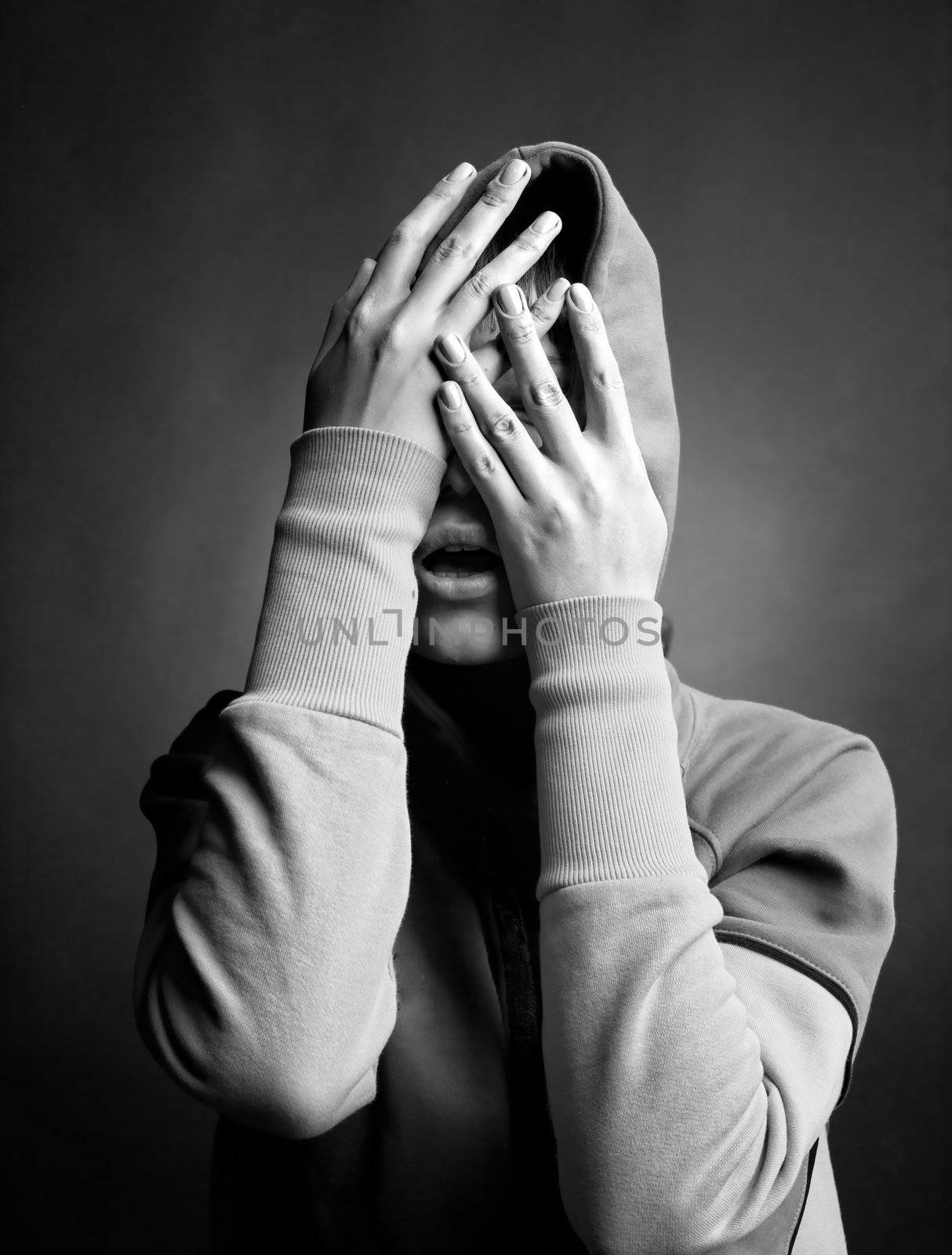young woman hide her face in her hands