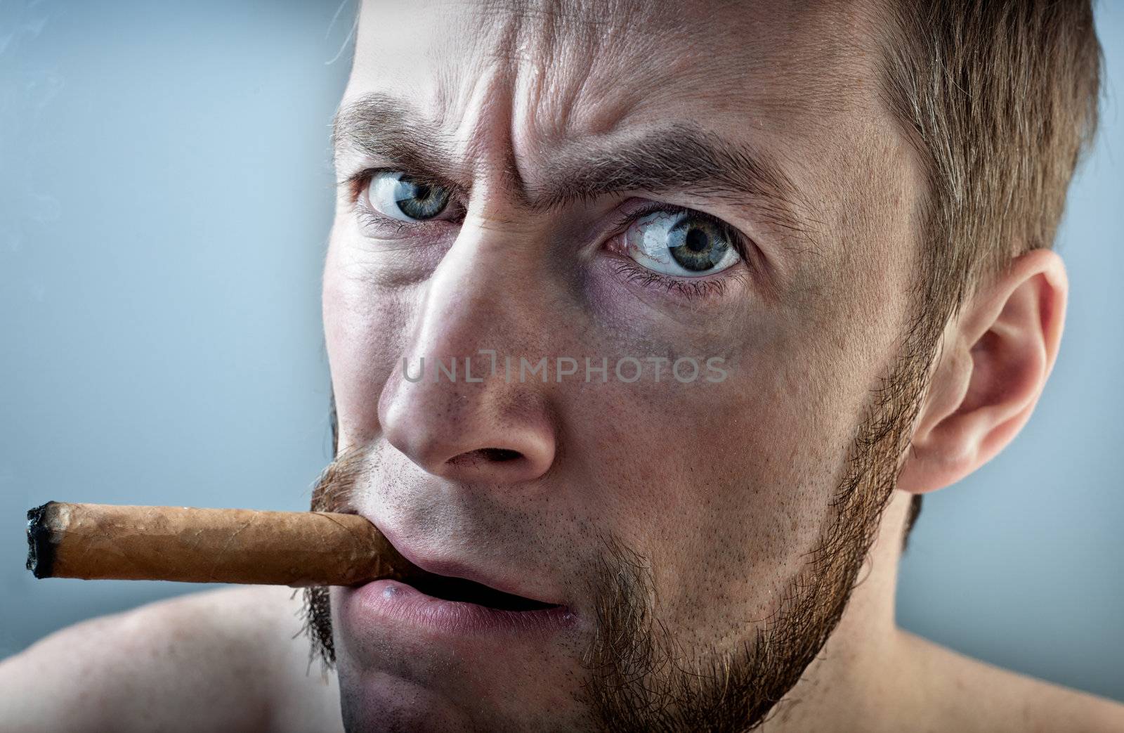 a man with a cigar, looking into the camera