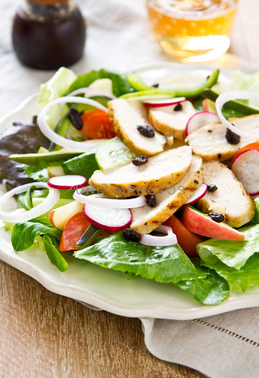 Grilled chicken with tomato ,lettuce ,radish and raisin salad
