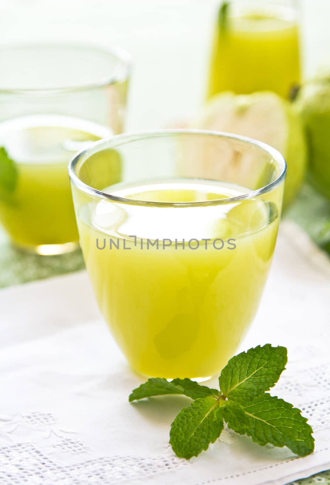 Guava juice with mint  in glasses and jug by fresh guava