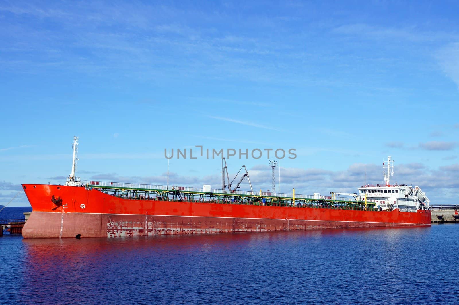 The tanker is moored in the port and loaded fuel