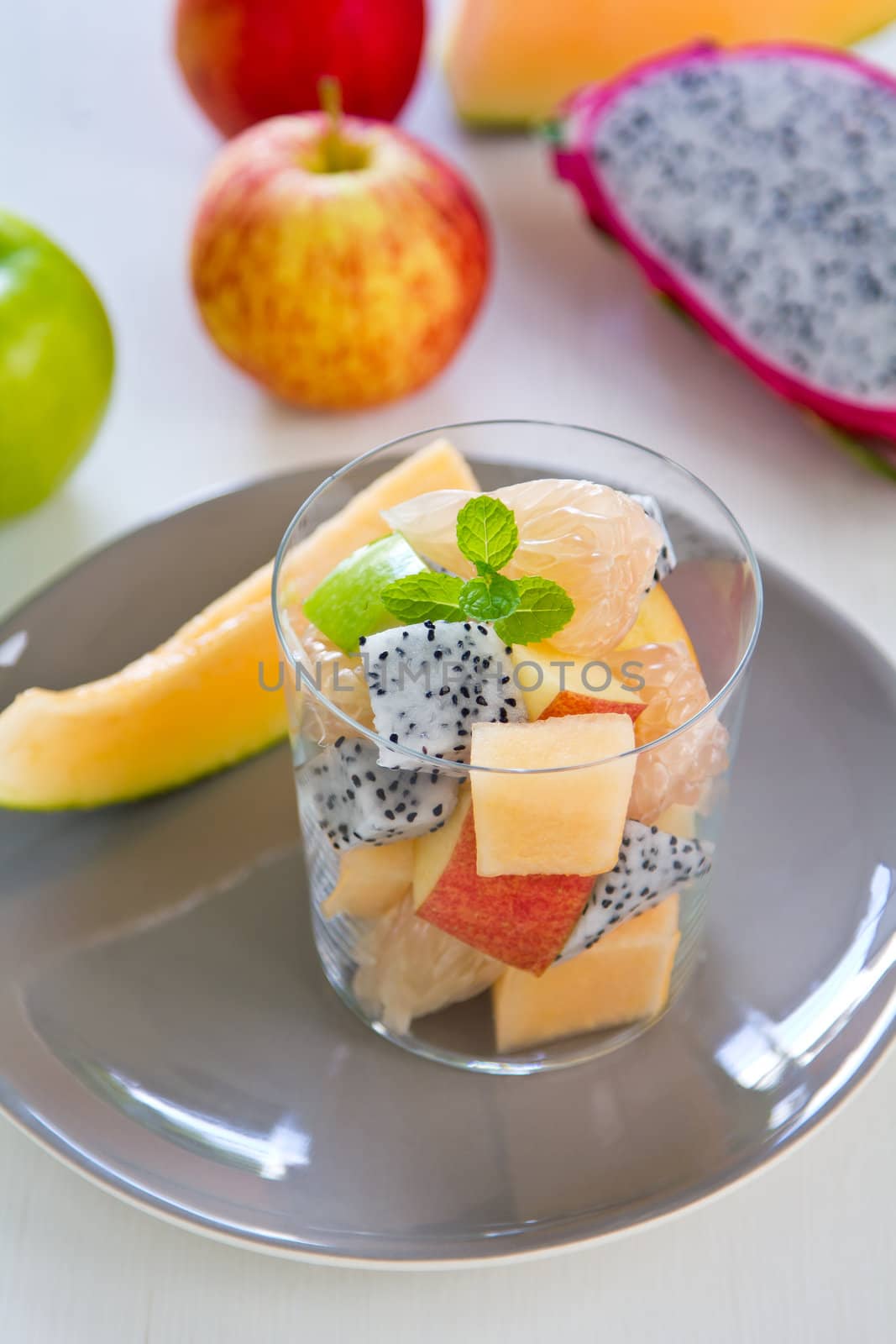 Fruit salad in glass [ apple,cantaloupe,dragon fruit ]
