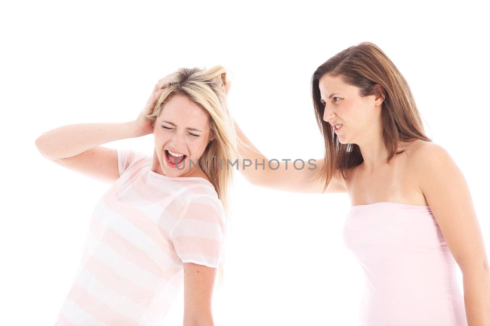 Vengeful woman pulling a second ladies hair with a look of spite and anger in retaliattion for an imagined wrongdoing 