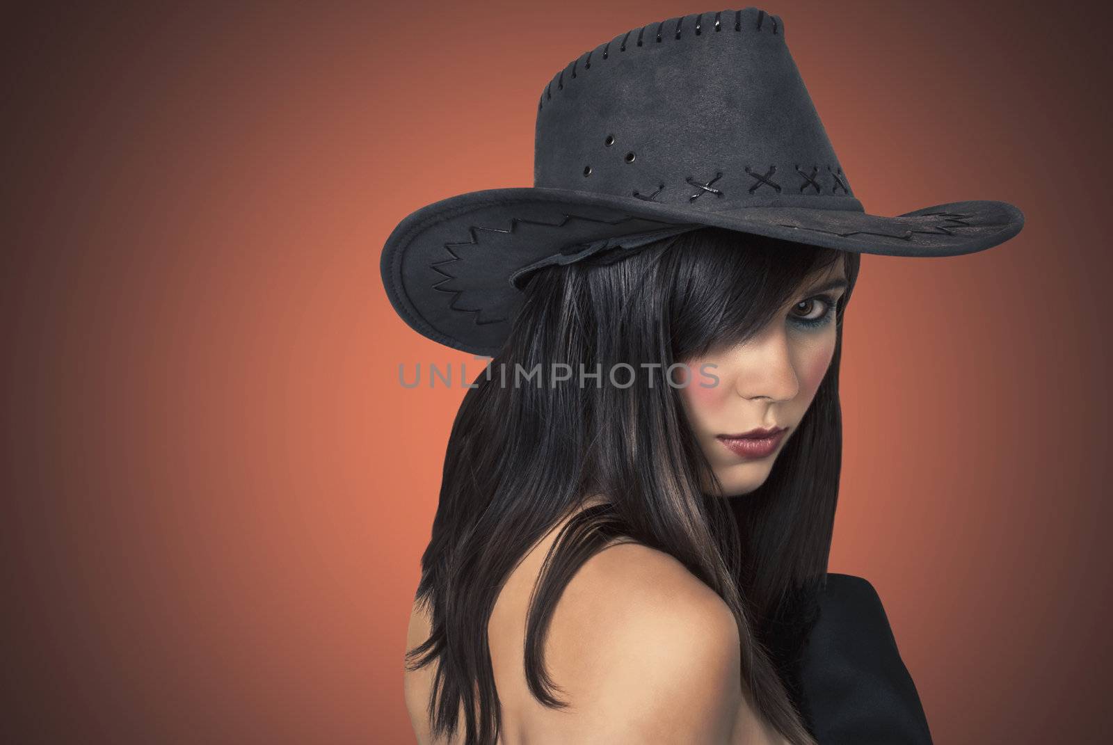 Photo sexy young woman in a hat cowboy.